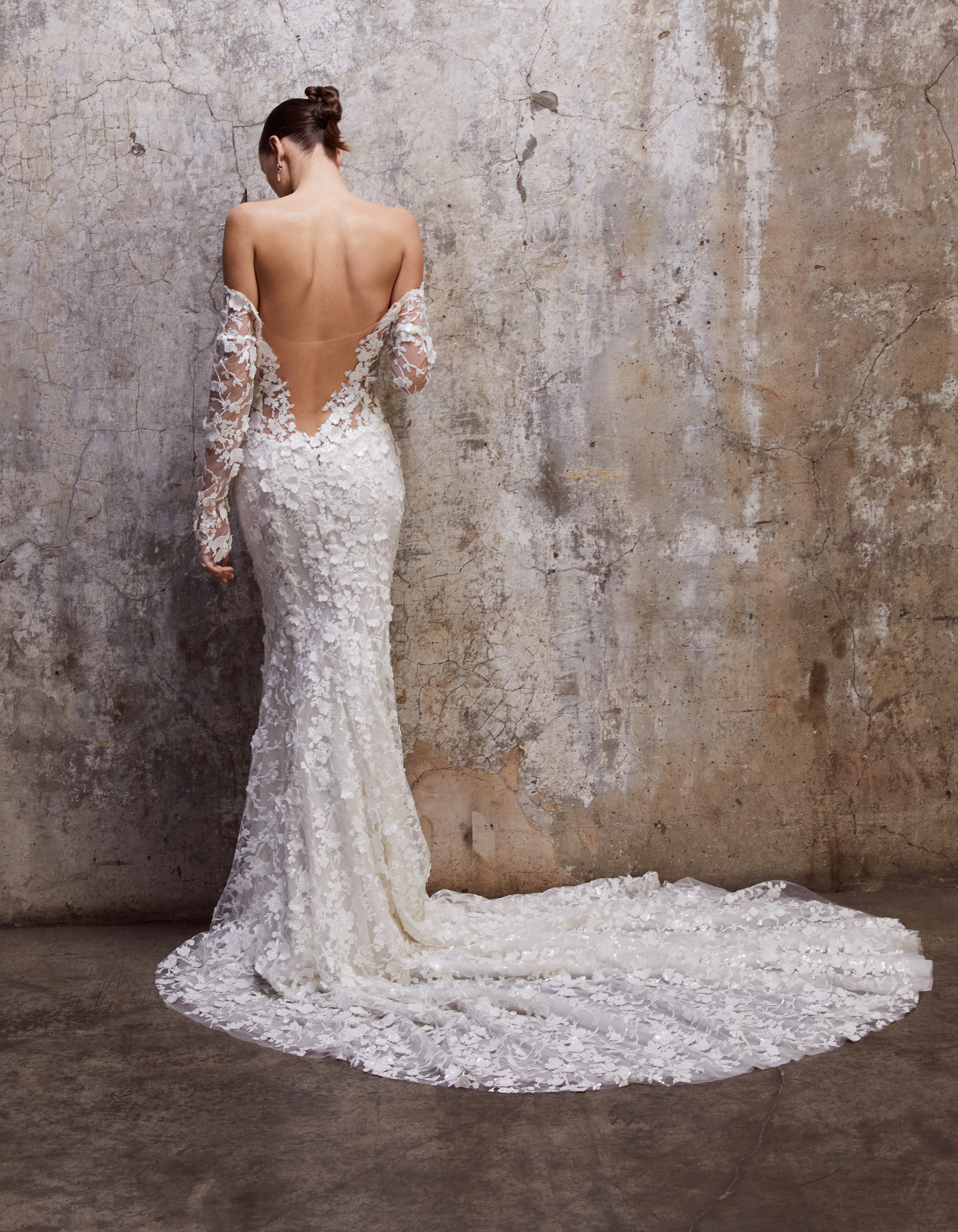 Back view of the Brooke gown, showing the deep V illusion tulle back, long sleeves, and floral lace train.