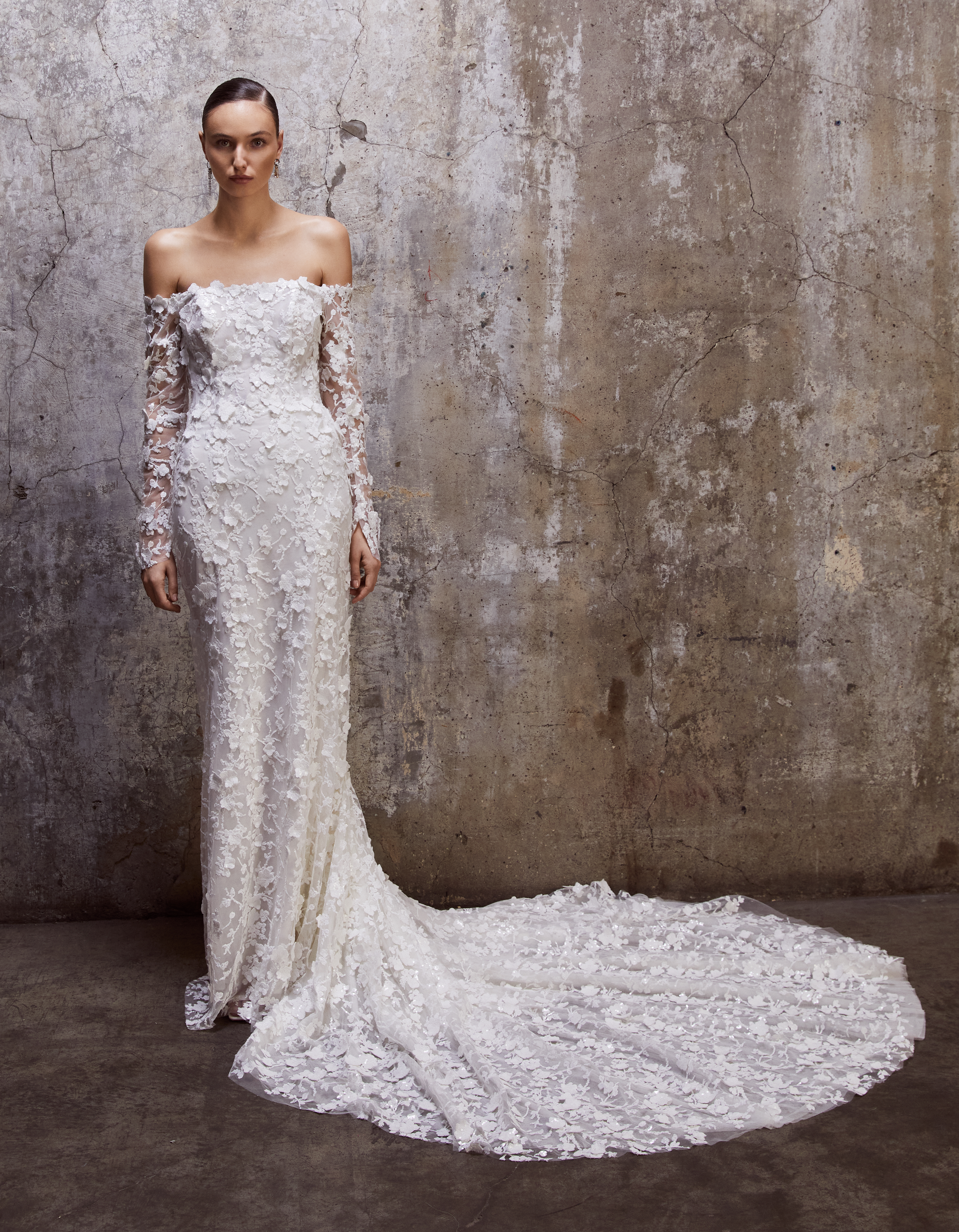 Bride wearing the Brooke strapless floral lace sheath gown with detachable long sleeves and a soft train.