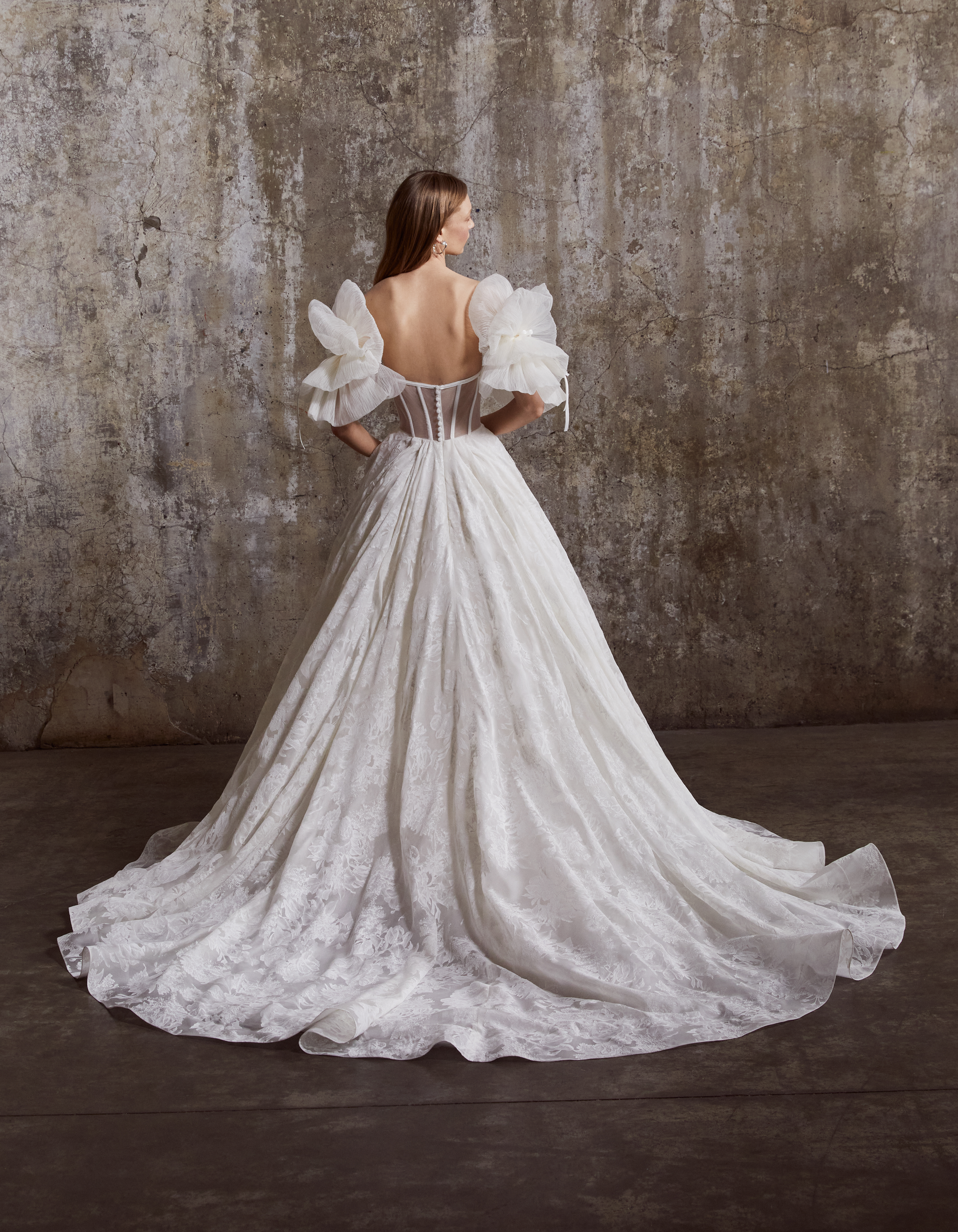 Back view of the Colette ballgown, showing the full floral organza skirt and soft train.
