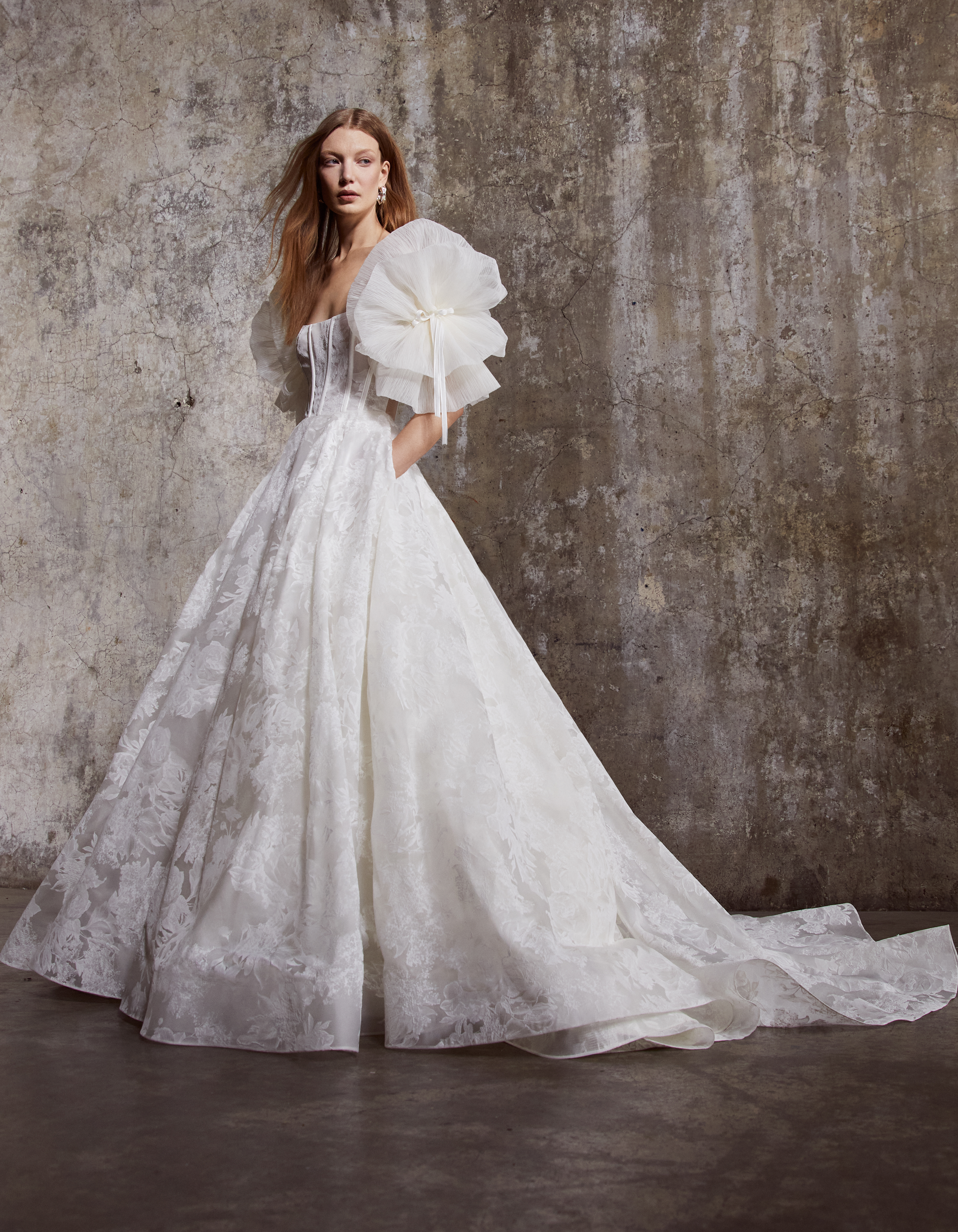 Bride wearing the Colette floral organza ballgown with detachable petal sleeves and full skirt.