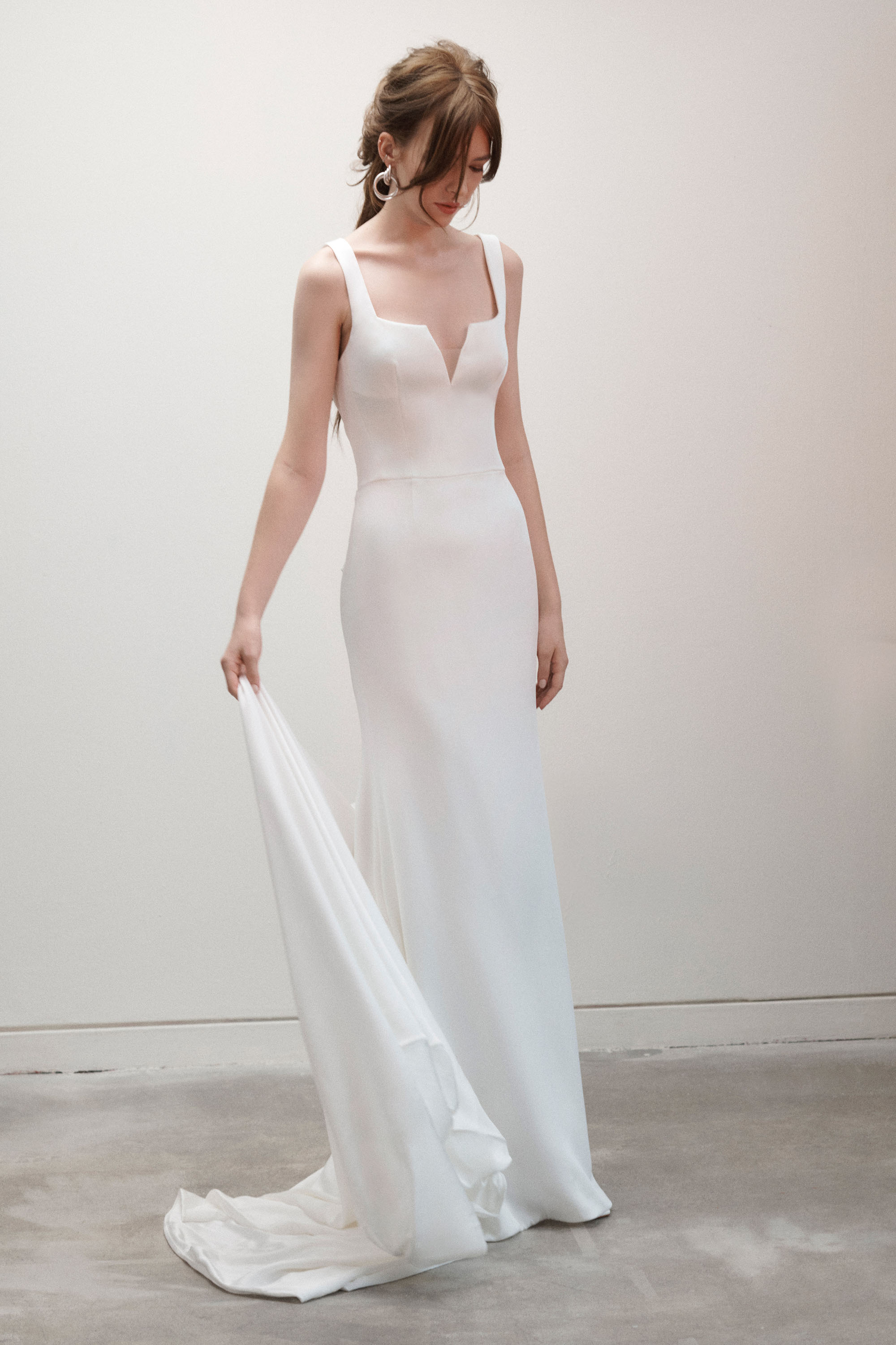 Front view of the Twiggy sheath gown, showing the wrapped bow detail and soft train.