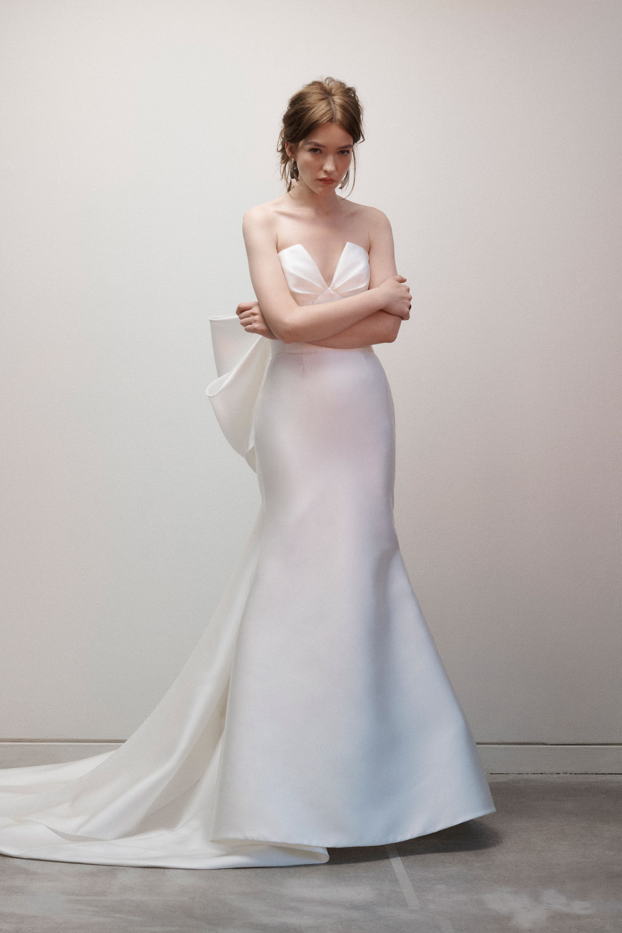 Bride wearing the Lauren gown with draped V-neck bodice, seamed midriff, and soft train.