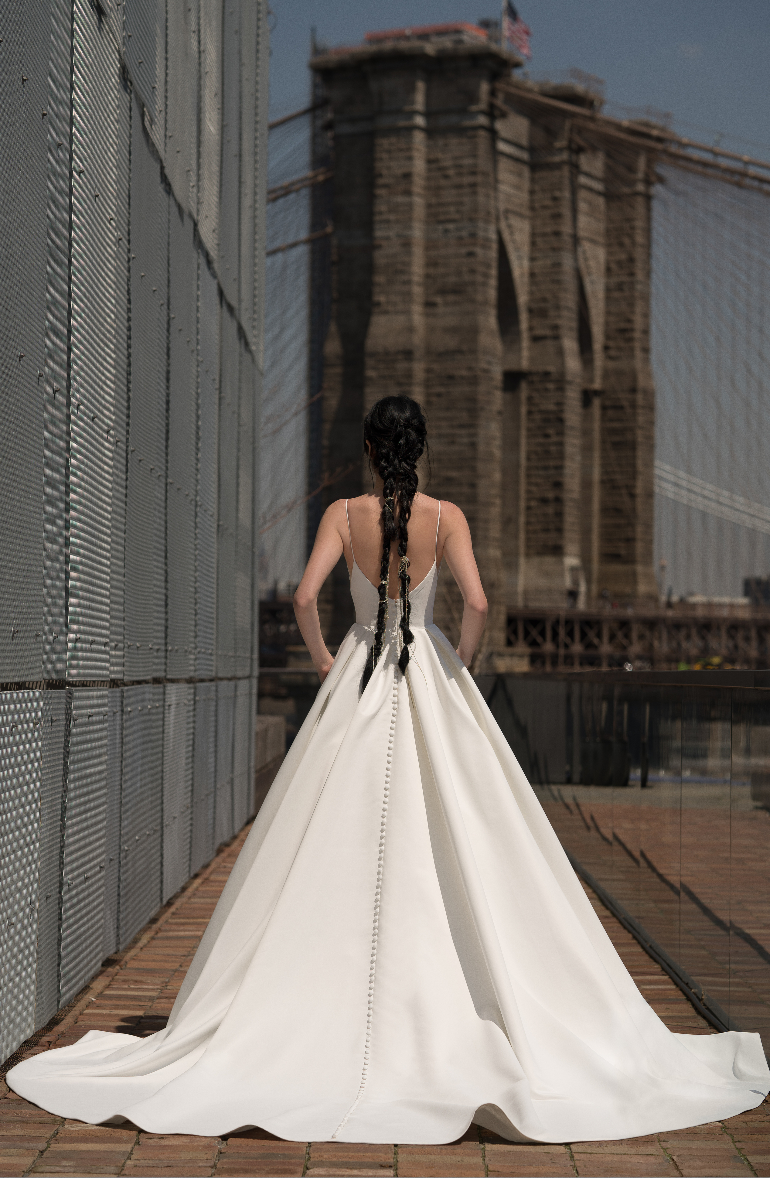 Back view of Crawford ivory ball gown with corseted bodice, full skirt, and pockets.