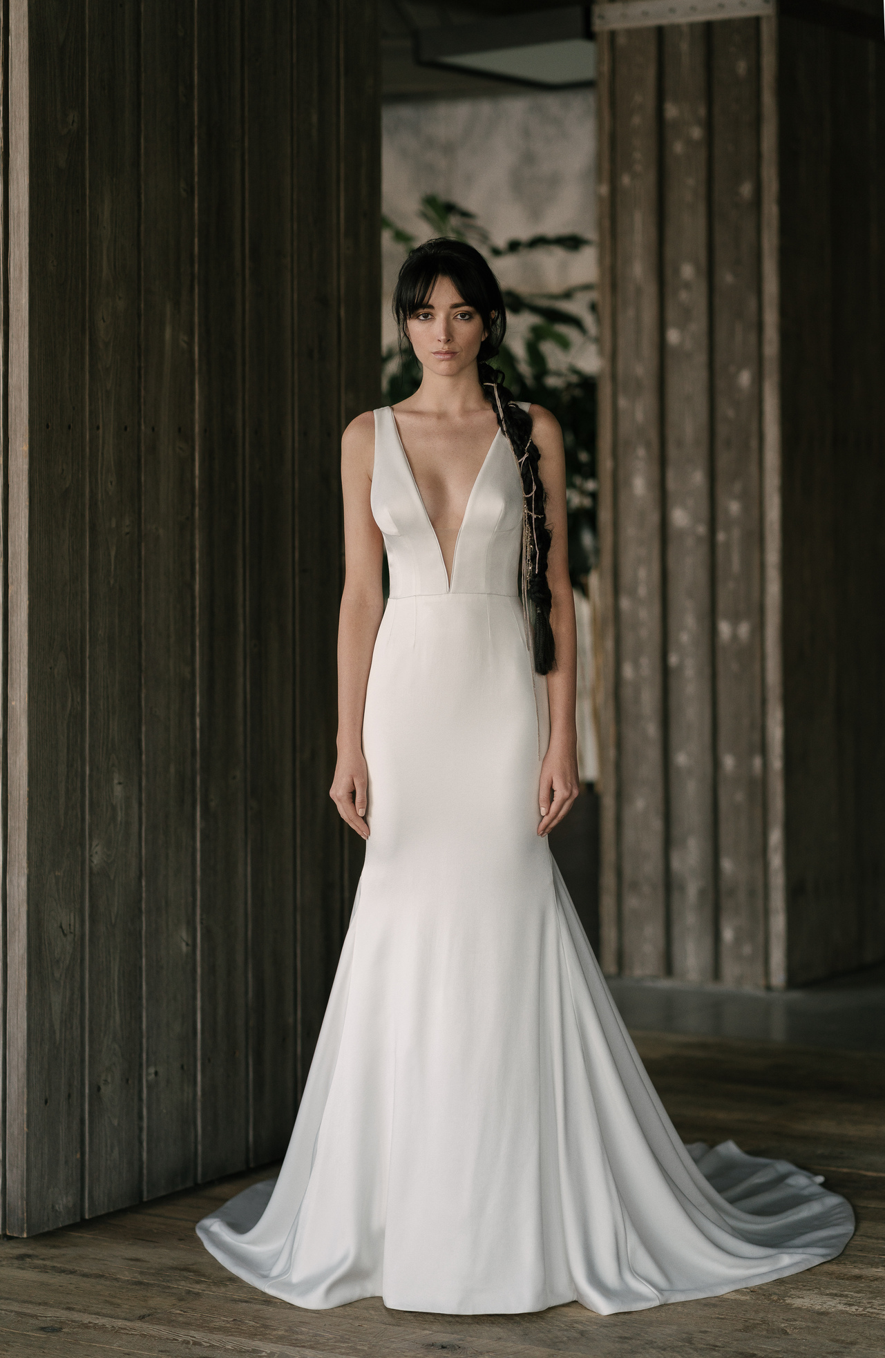Bride wearing the Roberts flared sheath gown with deep V bodice and soft train.
