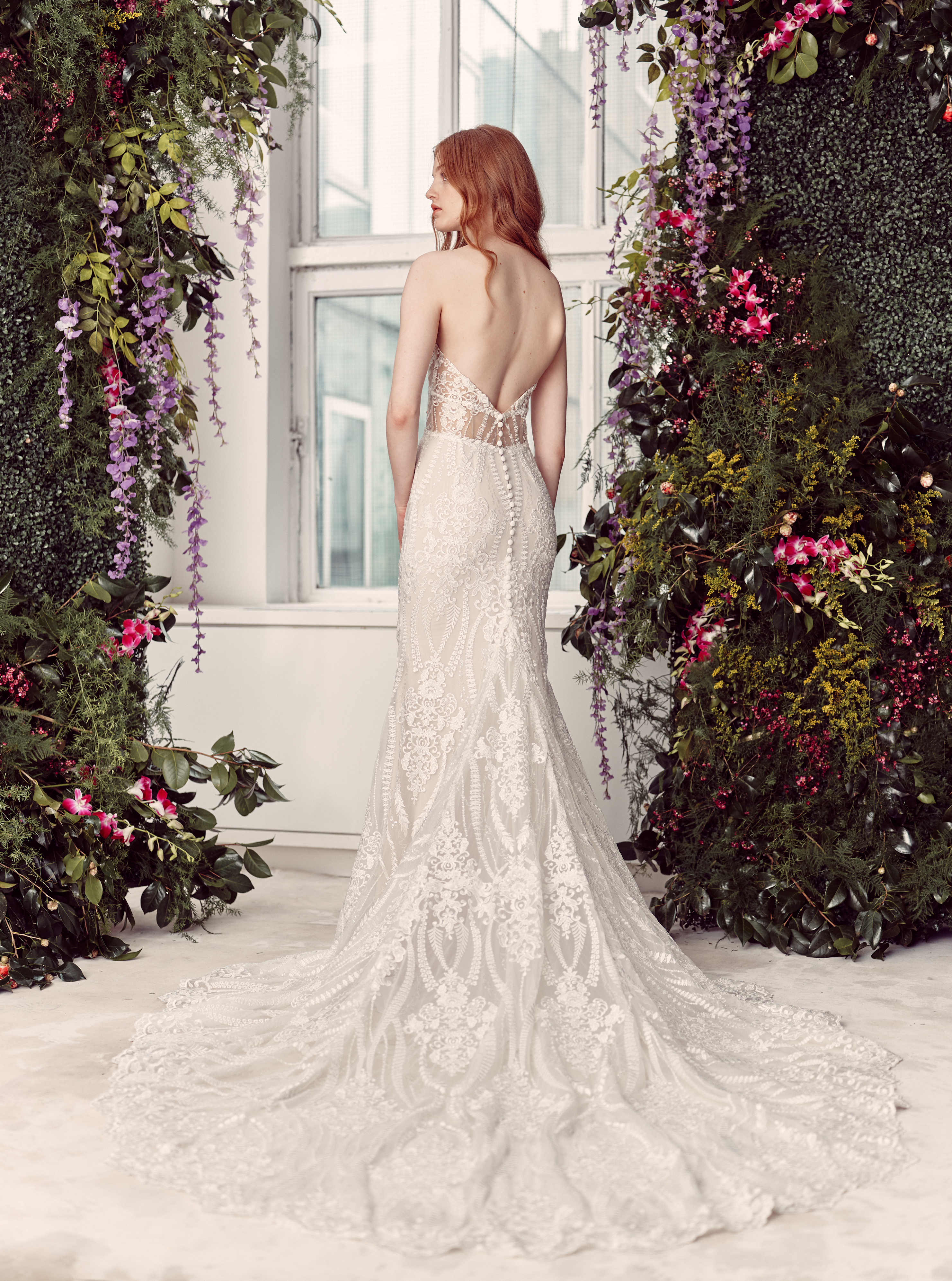 Back view of Aiden strapless flared gown with translucent bodice and flowing skirt.  Leave the blank image slots empty until another image is selected.
