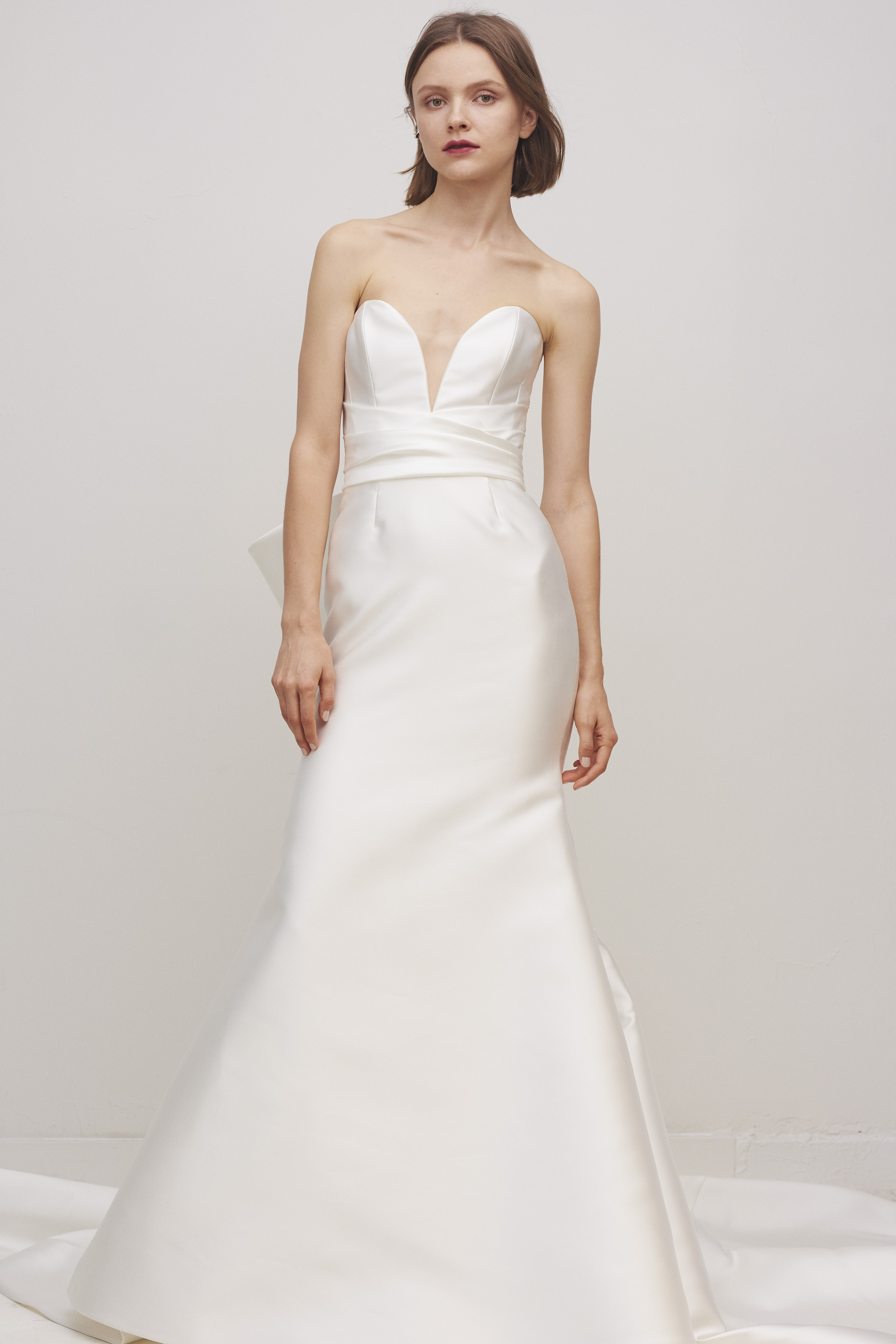 Bride wearing the Oxford fit-and-flare gown with deep sweetheart neckline and clean silk silhouette.