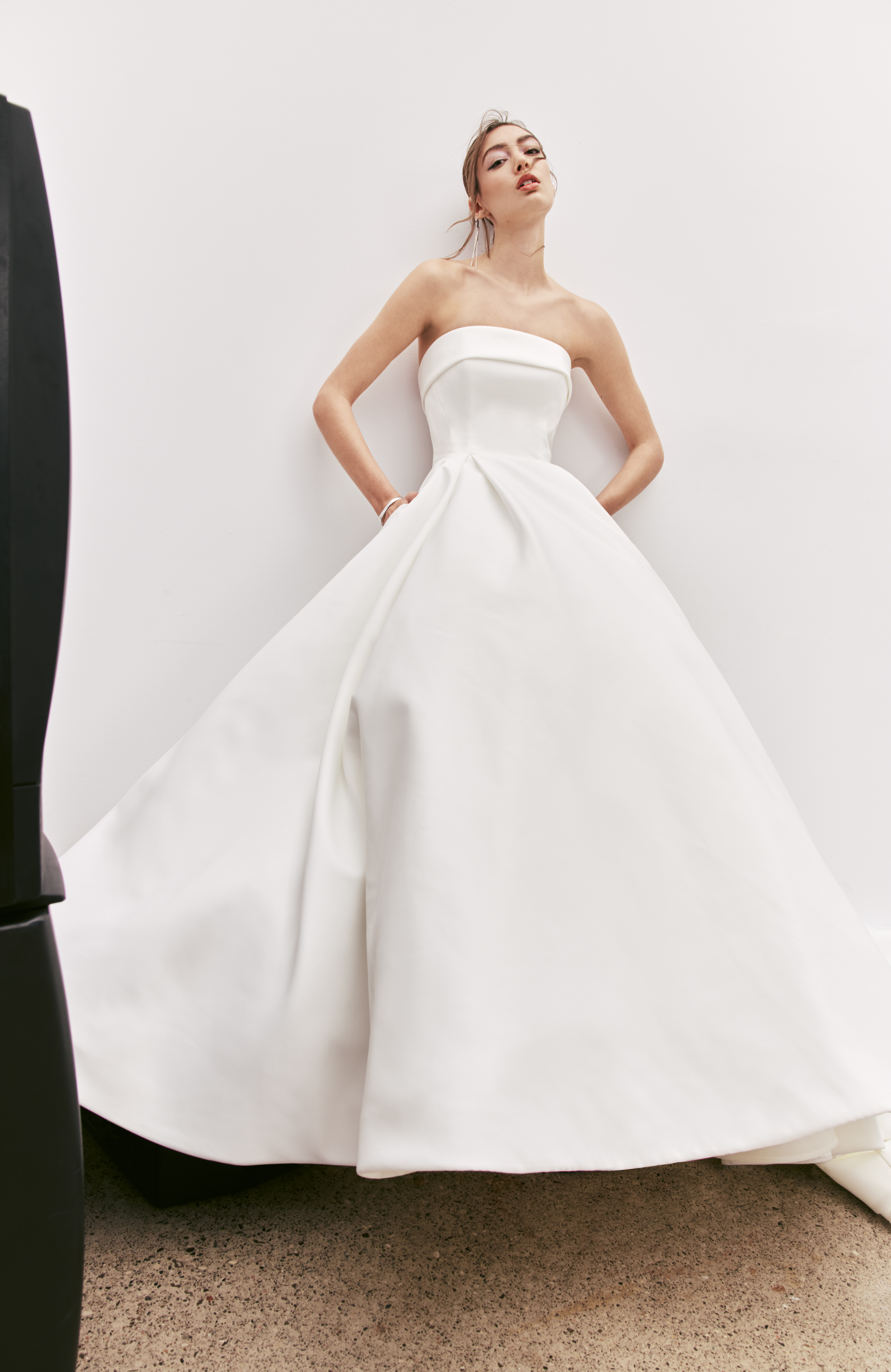Maci banded strapless ball gown with back cutout, bow detail, and full skirt, shown from the front.