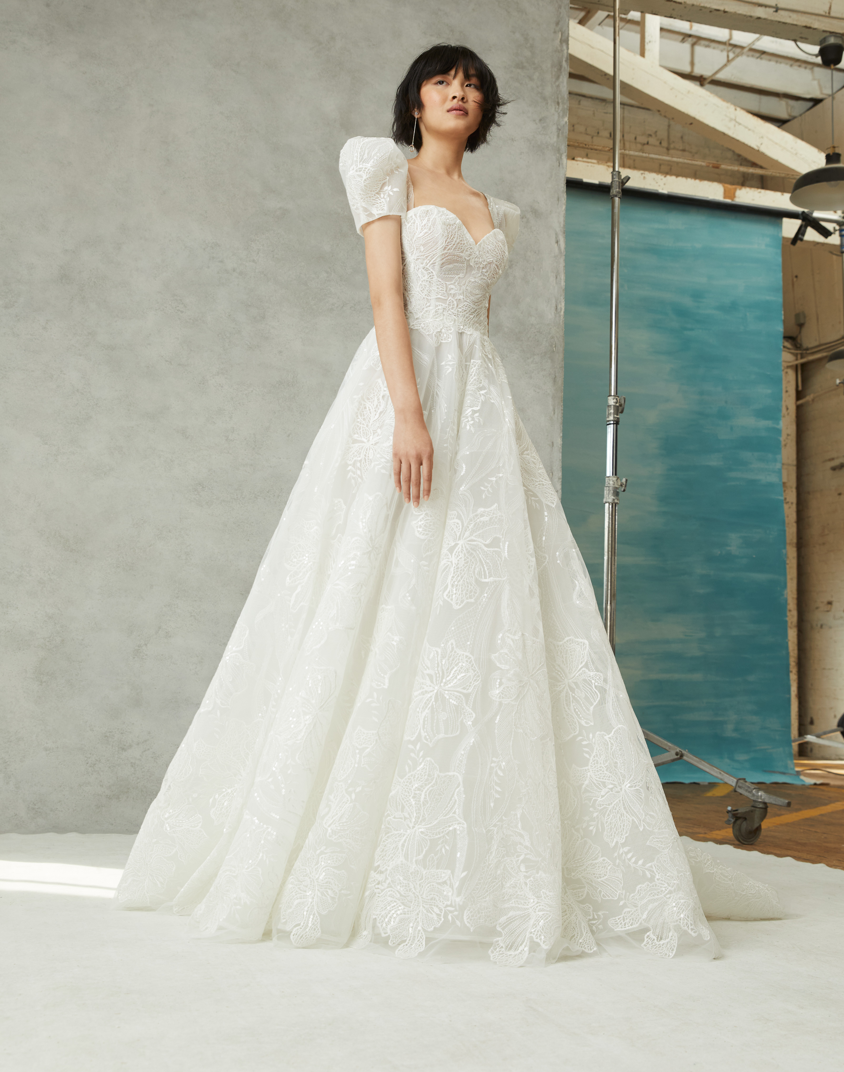 Sofie ivory ball gown with translucent bodice, tiered horsehair skirt, and detachable puff sleeves, shown from the front.