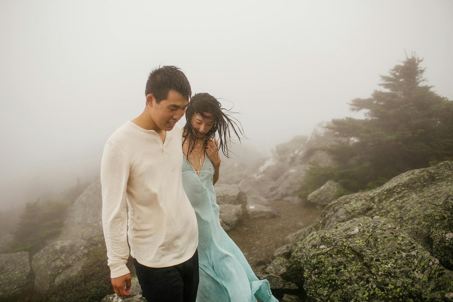 Couple walking in the fog of Mount Mansfield near Stowe, VT