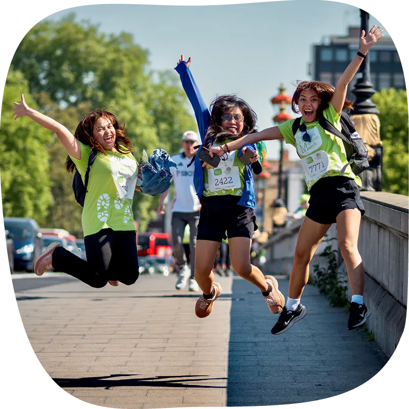 Marsden March participants smiling and jumping in the air. 