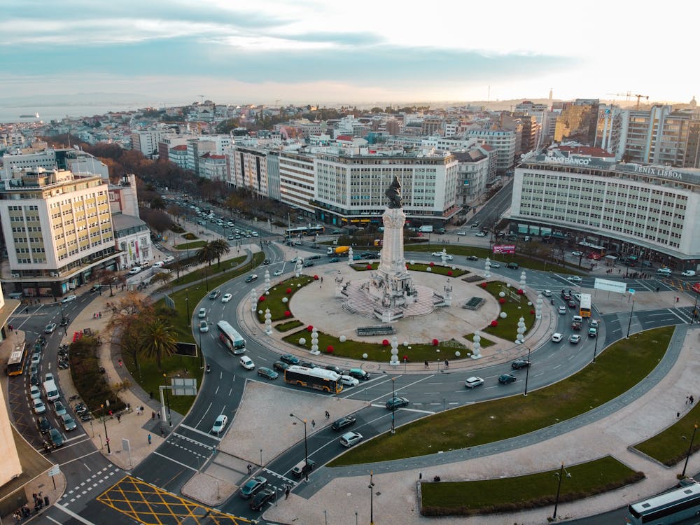 With the rental car at a roundabout in Lisbon During a road trip tour in Portugal, you can visit Lisbon