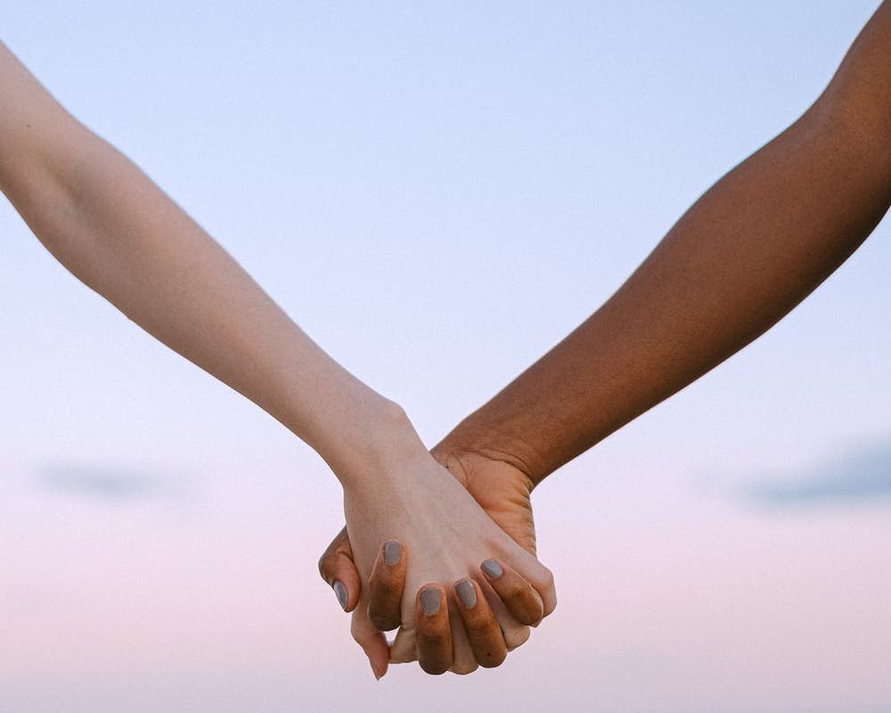 Two people holding hands