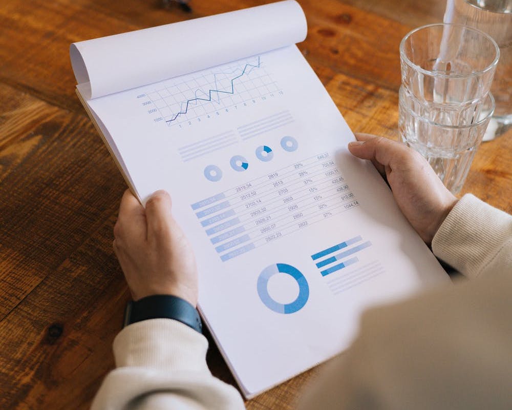 Man holding notebook with data