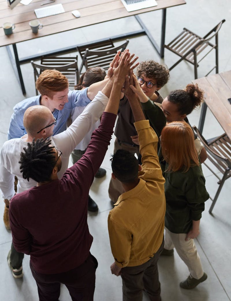 Several employees high fiving together.