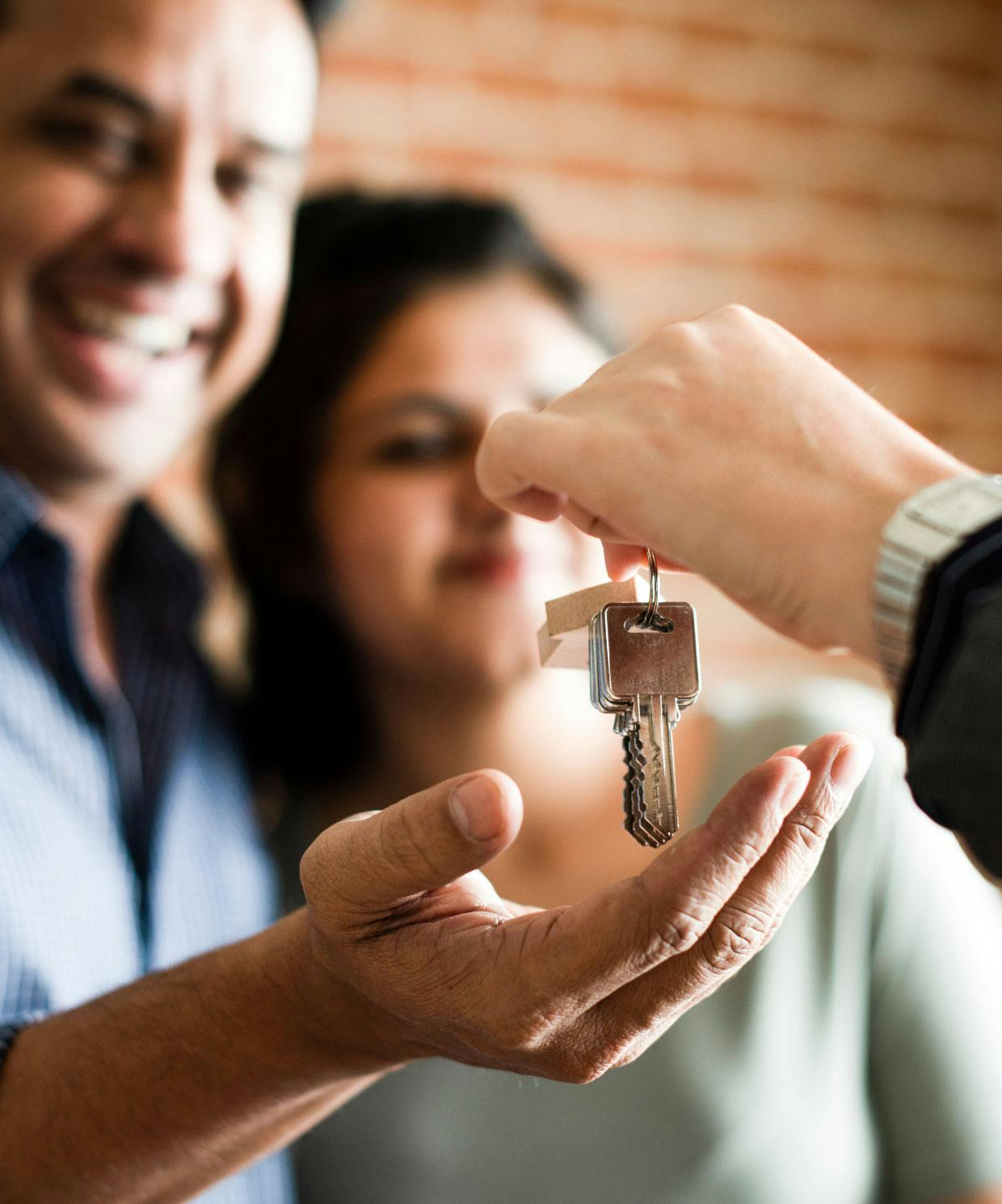 real estate agent handing keys