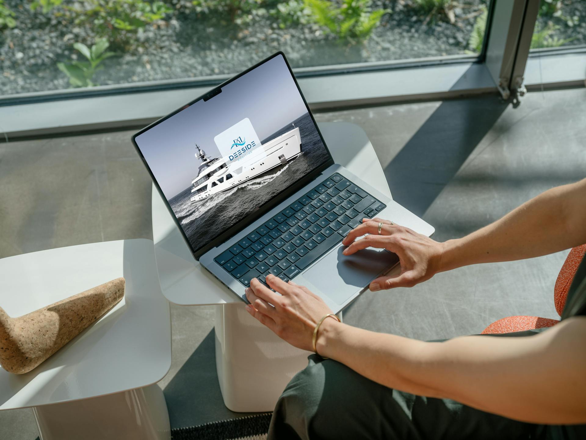 a laptop on a table being used by a person