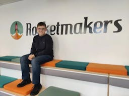Daniel sat on tiered seating in the office