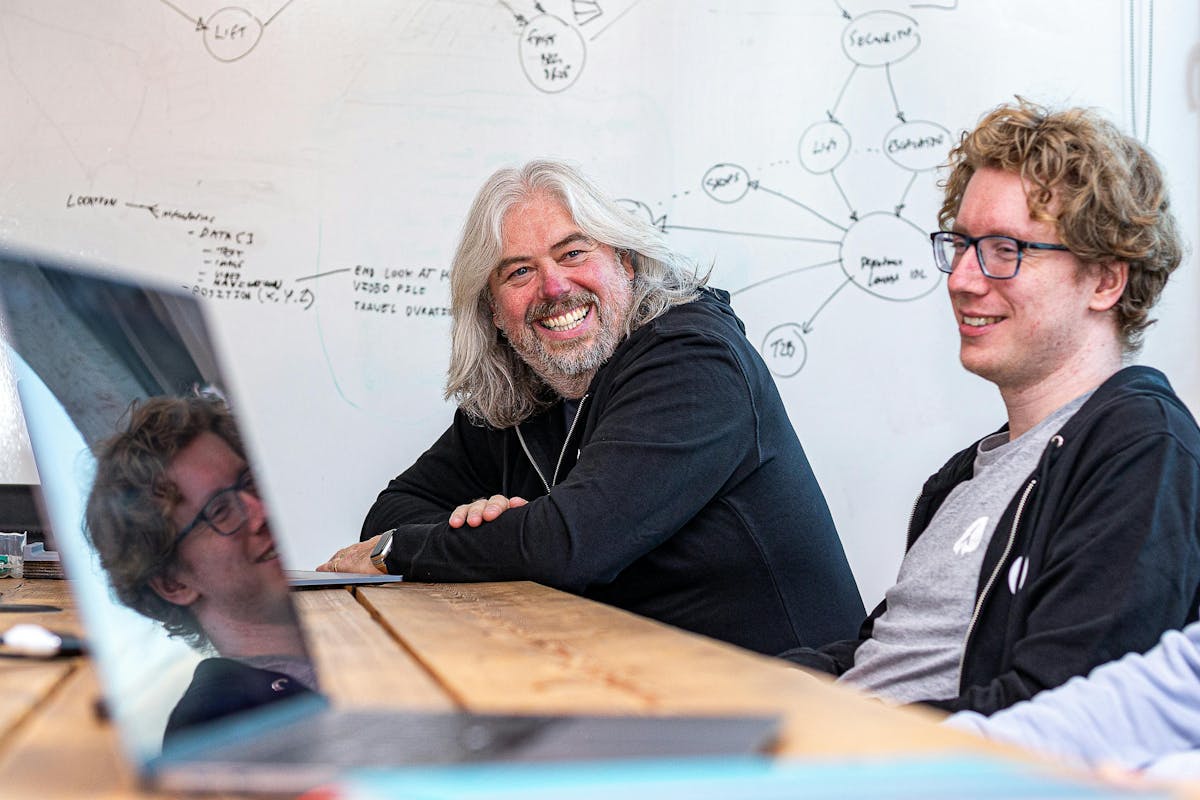 Photo of two Rocketmakers team members smiling while in front of a whiteboard.