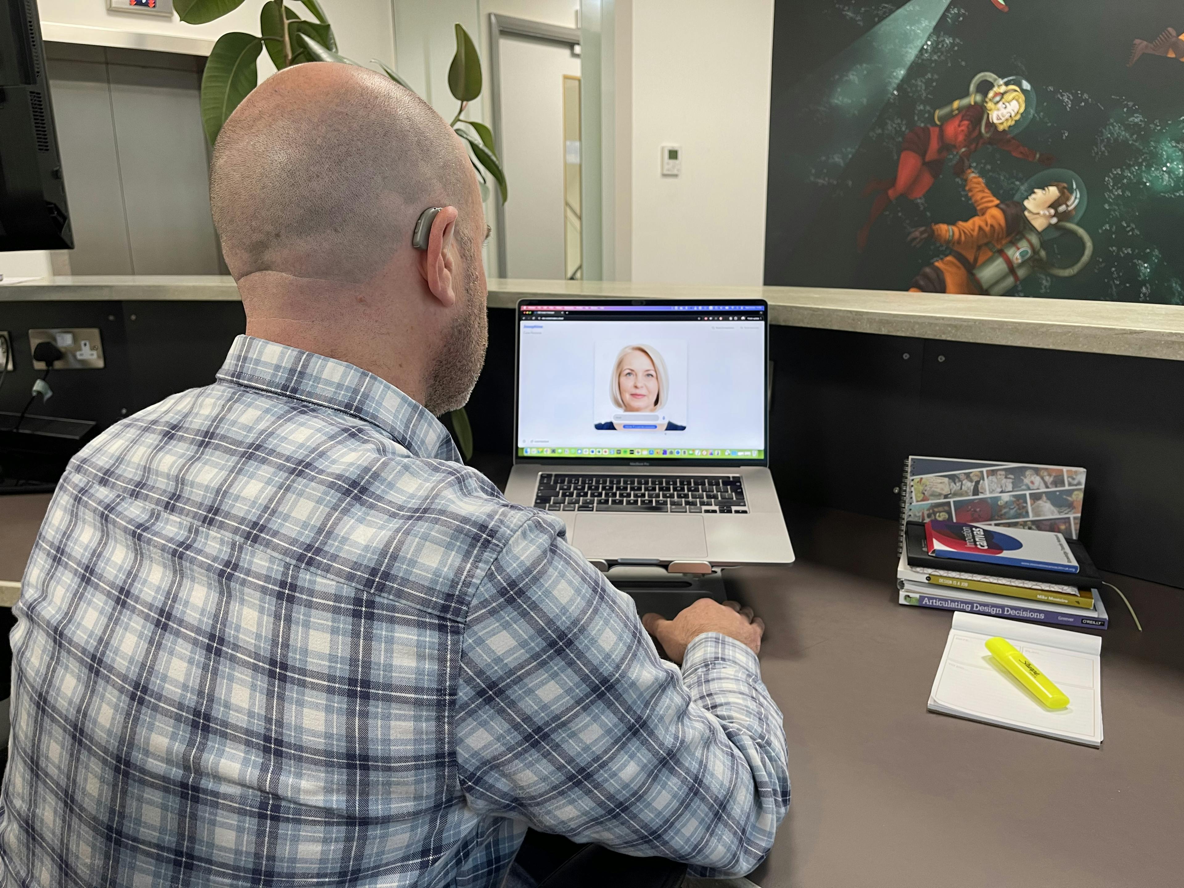 A man at a desk interacting with an AI customer persona
