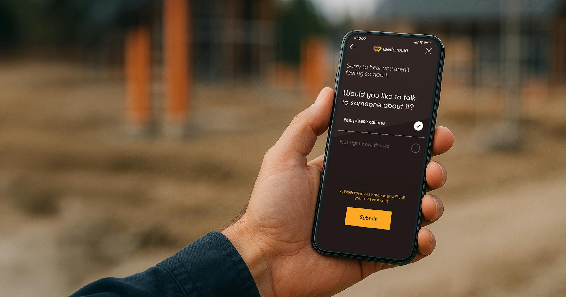 Hand holding a smartphone showing a the Wellcrowd app for workplace wellbeing on the screen