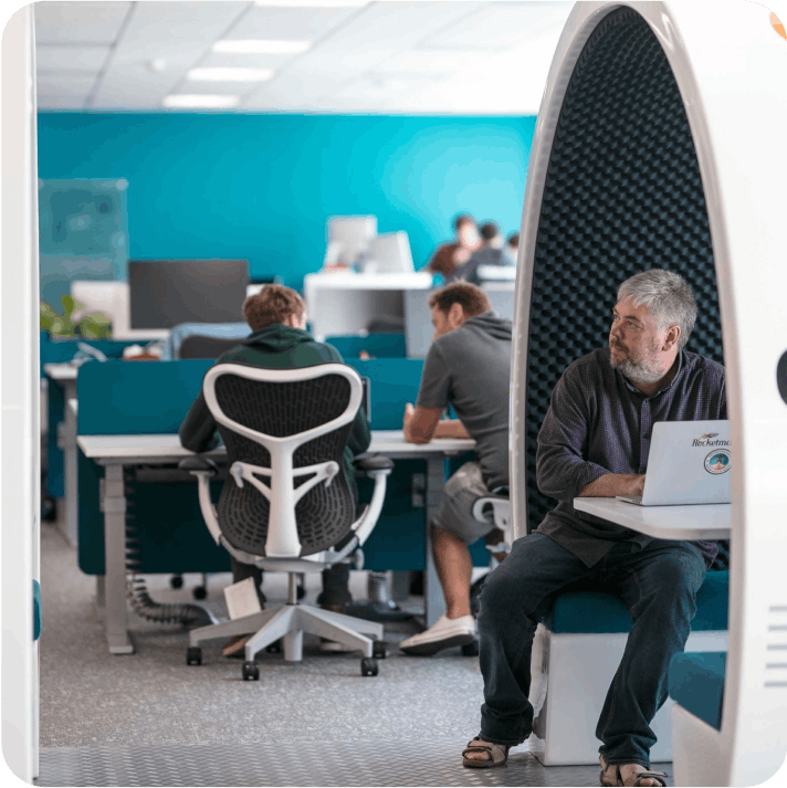Person working in a rocket shaped co-working space