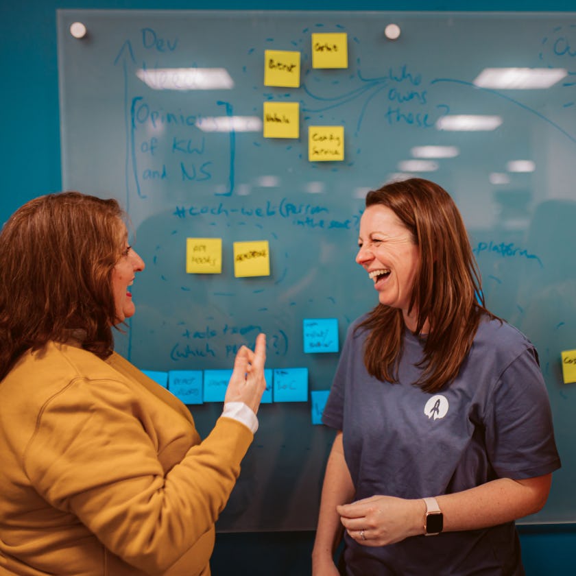 Two people having a meeting and laughing