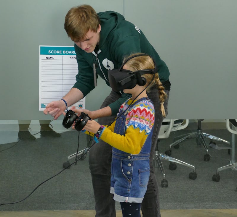 Ben helps girl with VR game