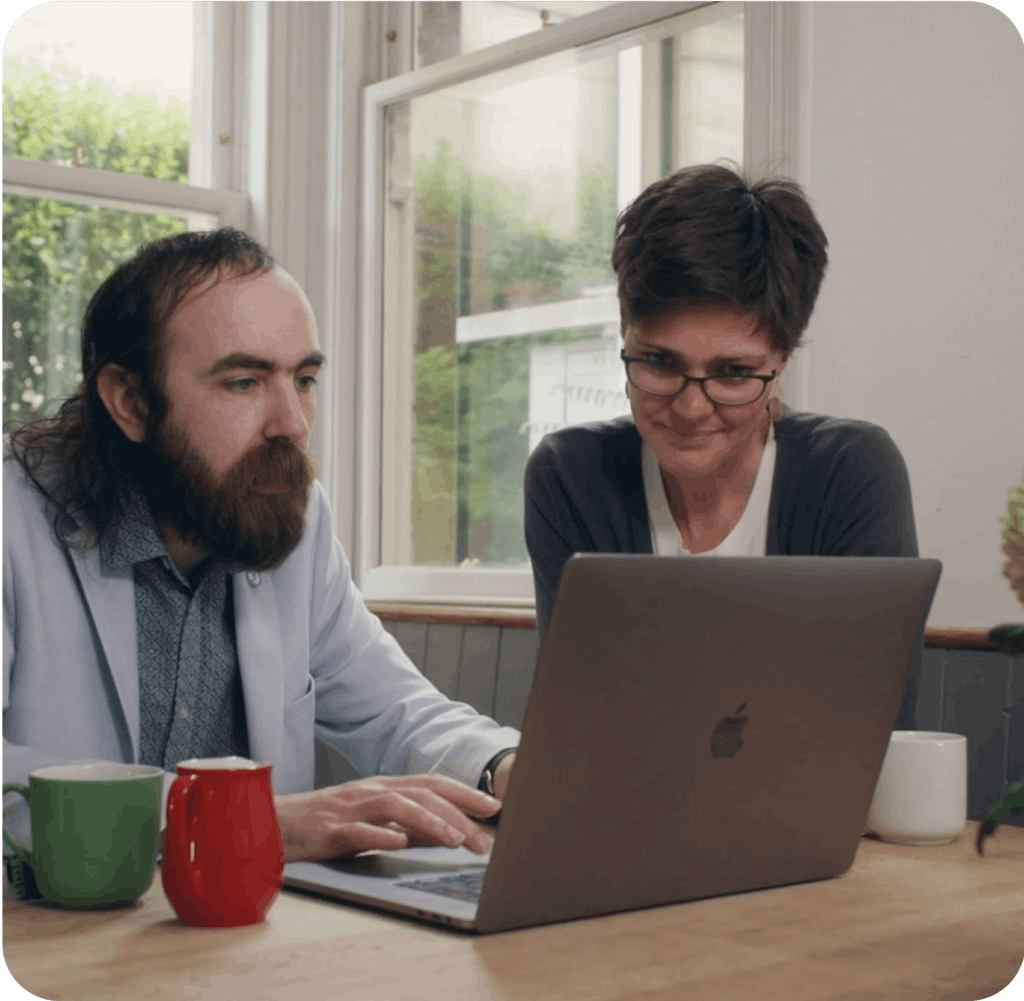 Consultant and client working on a laptop