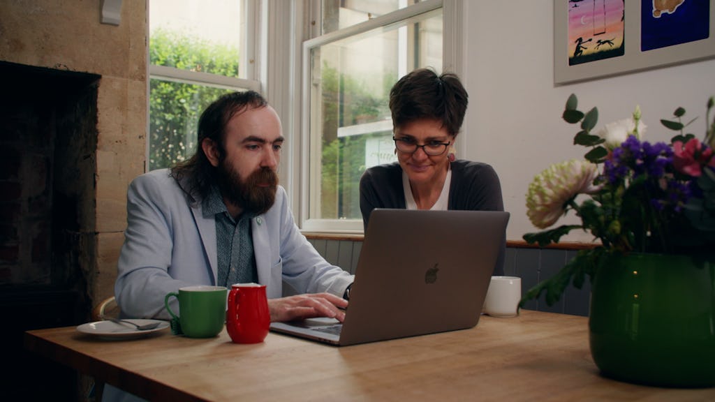 Developer and client looking at a laptop