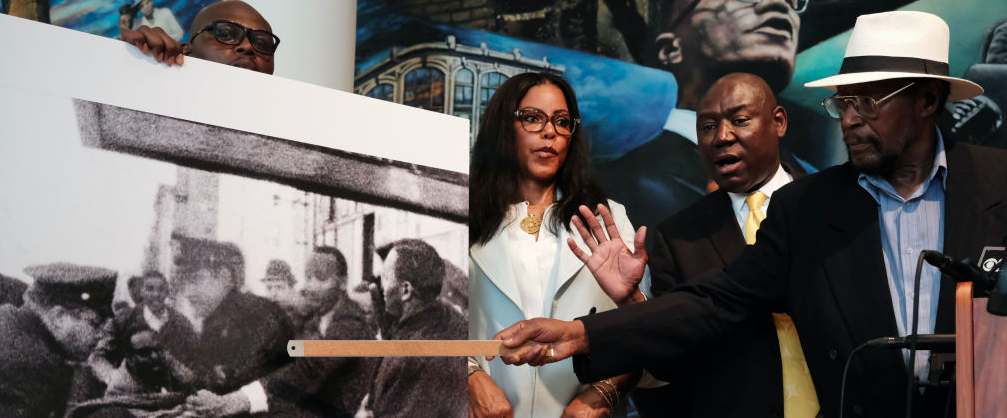 Mustafa Hassan, 84, an associate of Malcolm X, points to himself in a picture following the assassination of Malcolm X during a news conference with Civil rights attorney Ben Crump and and Malcolm X's daughter IIyasah Shabazz on July 25, 2023 in New York City. They allege more information has been discovered which they say points to efforts by the FBI to cover up a conspiracy to murder Malcolm X. Crump and his team said they were unveiling the information, including a new witness speaking for the first time, to show negligence or a possible cover up in the investigation of the famed civil rights leader. Mr. Hassan was at the scene of the assassination but was never interviewed by police. He allegedly heard police ask if a suspected gunman was "with us" after police witnessed Malcolm X's supporters beating him. Hassan said he saw another gunman, which he has stated in an affidavit. 