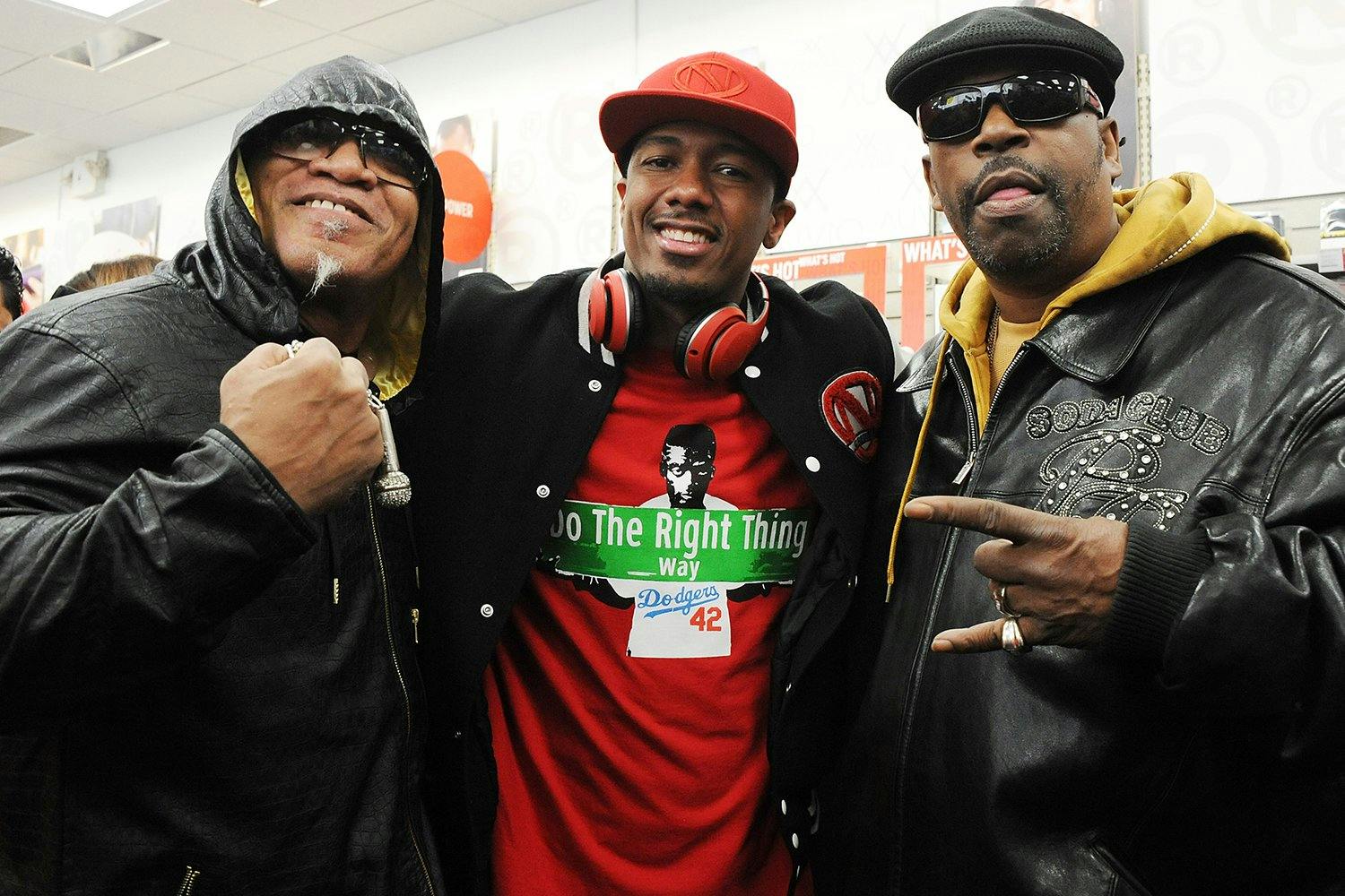 Nick Cannon (C) poses with rappers Melle Mel (L) and Grandmaster Caz during his launch of Ncredible product line at Radioshack on February 23, 2016 in New York City.