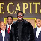 NEW YORK, NEW YORK - OCTOBER 18: Sean “Diddy” Combs poses for a photo with students during a surprise visit at his Capital Preparatory School in the Bronx on October 18, 2022 in New York City. 