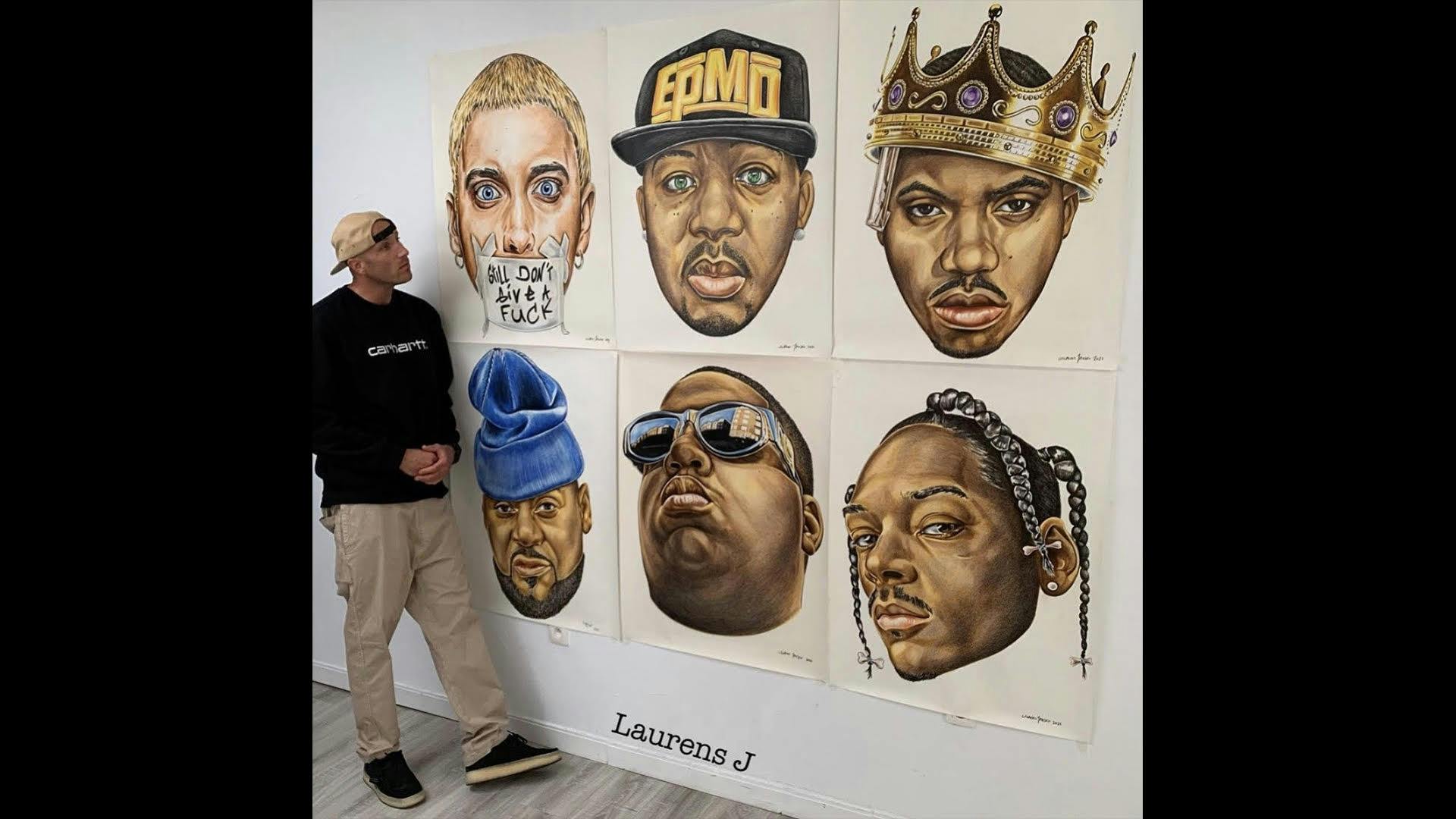 Laurens Jansen stands in front of portraits of Eminem, EPMD, Nas, Ghosfact, Biggie, and Snoop Dogg