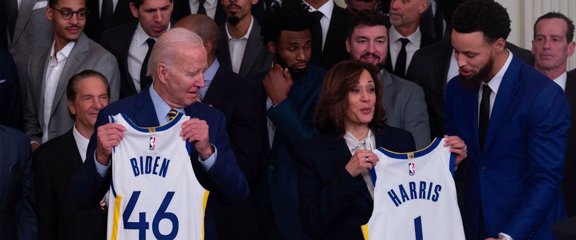 US President Joe Biden and US Vice President Kamala Harris are presented with jerseys from members of the Golden State Warriors basketball team during a celebration for their 2022 NBA championship, in the East Room of the White House in Washington, DC, on January 17, 2023. 