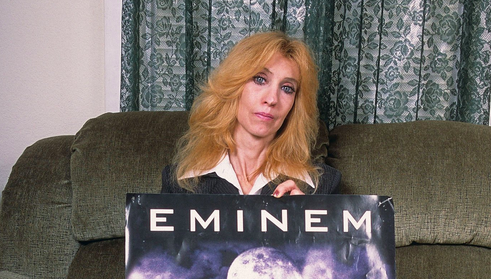 DETROIT, MI - SEPTEMBER, 2005: (EXCLUSIVE COVERAGE) Eminem's mother Debbie Mathers holds a poster with a hand written message during a portrait session at her home in September, 2005 in Detroit, Michigan. 