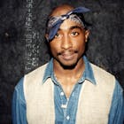 Rapper Tupac Shakur poses for photos backstage after his performance at the Regal Theater in Chicago, Illinois in March 1994