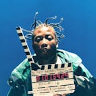 Ol Dirty Bastard poses with a clapperboard on the set of Shimmy Shimmy Ya