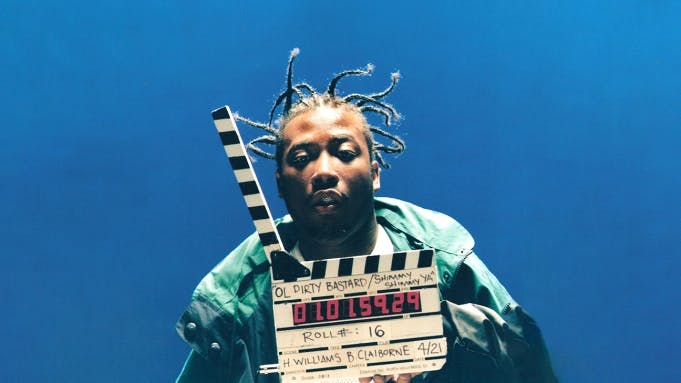 Ol Dirty Bastard poses with a clapperboard on the set of Shimmy Shimmy Ya