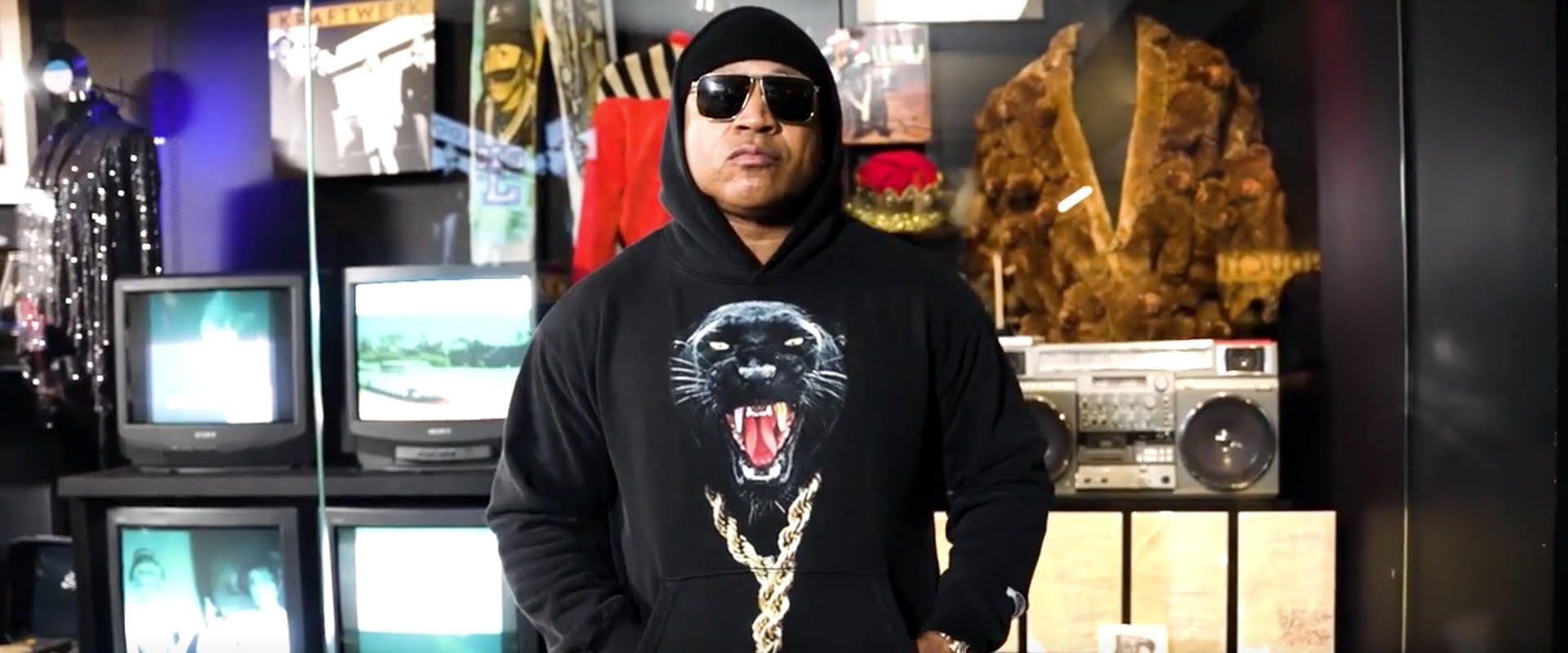 LL COOL J stands in front of his Rock and Roll Hall of Fame Exhibit