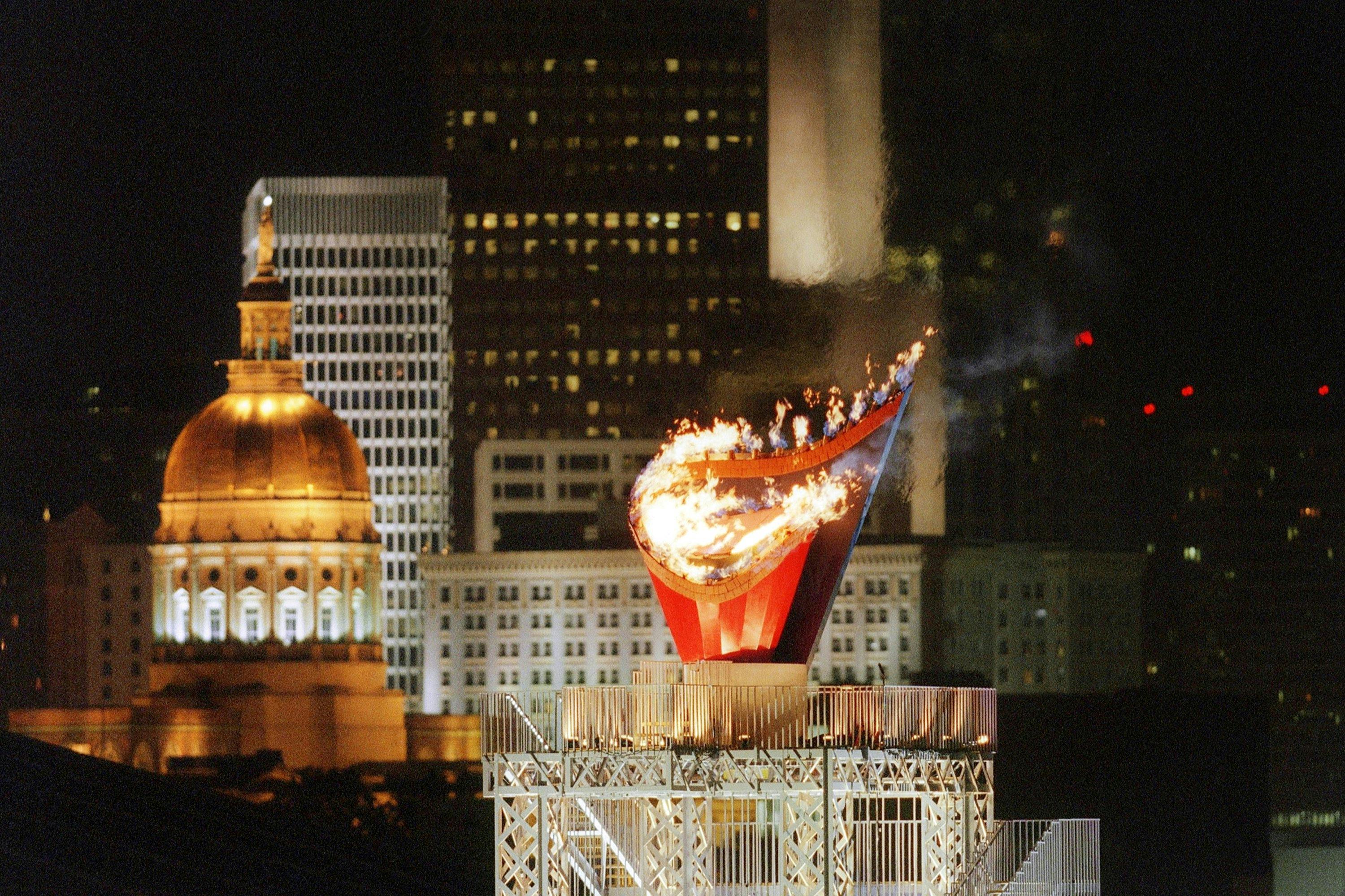 The Olympic flame as seen in front of the skyline of the southern Georgian city of Atlanta early 20 July 1996 at the end of the Centennial Olympic Games opening ceremony. Photo: PEDRO UGARTE/AFP via Getty Images