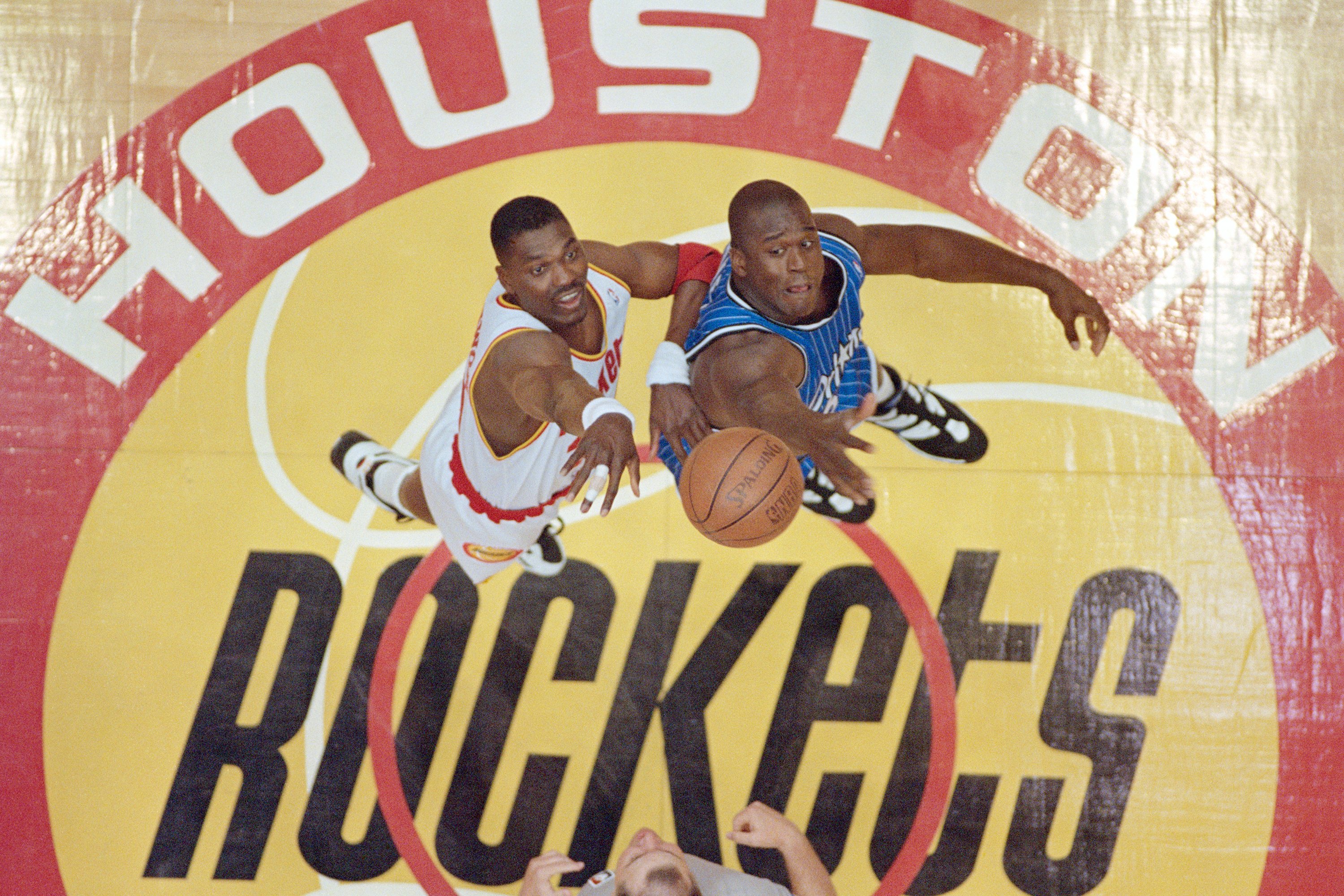 Hakeem Olajuwon of the Houston Rockets and Shaquille O’Neal of the Orlando Magic