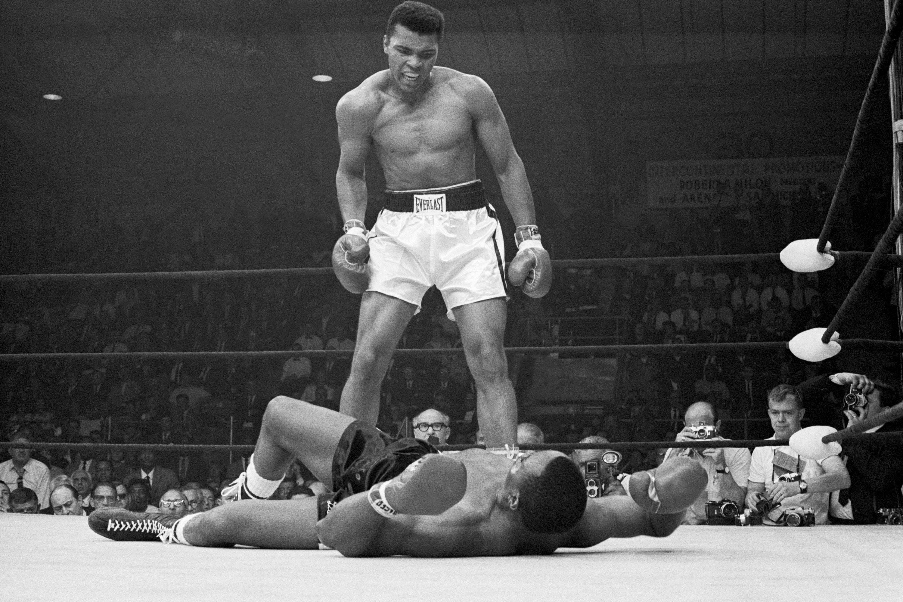 Heavyweight champion Muhammad Ali stands over Sonny Liston