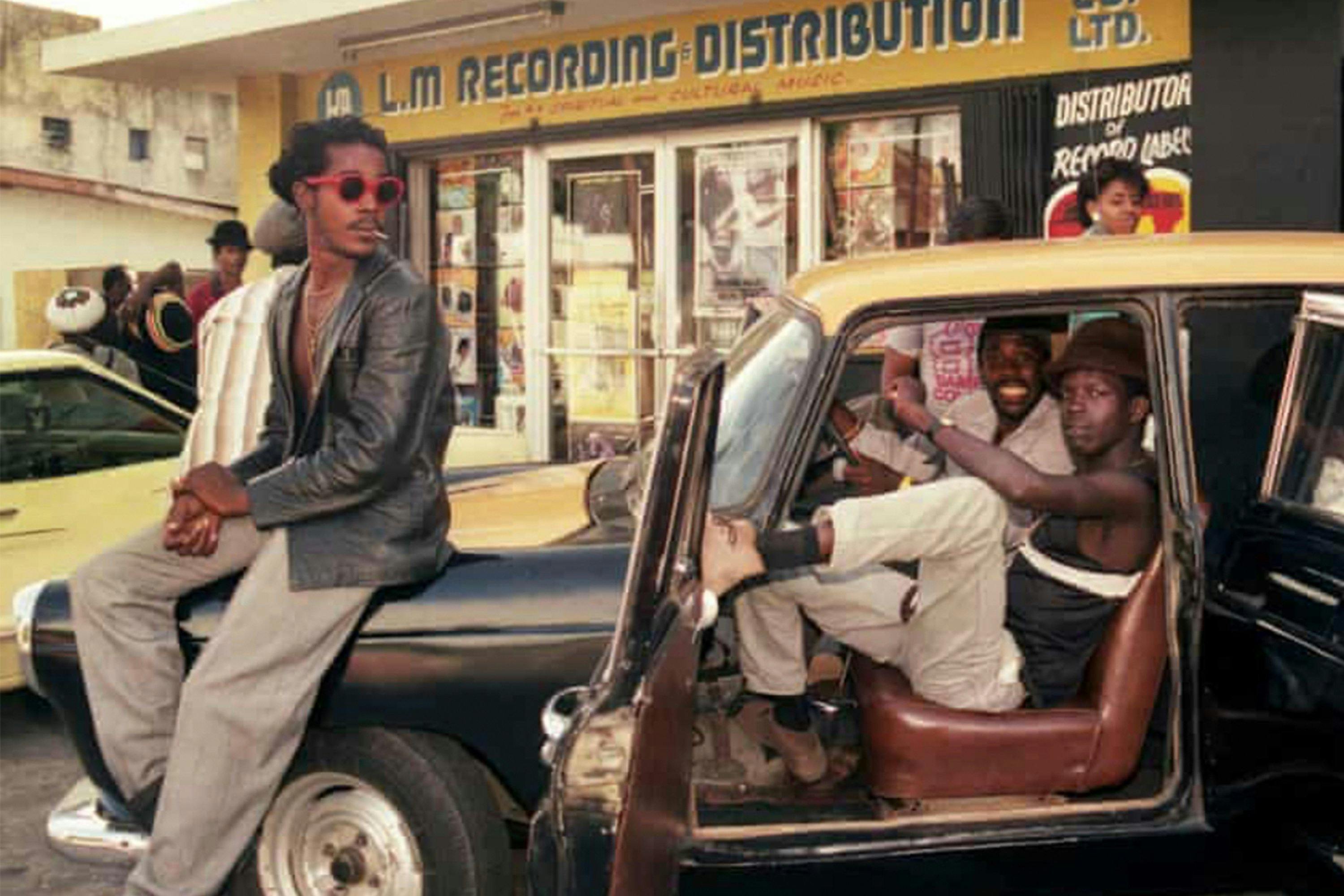 A group of people hang out in front of a Jamaican dancehall