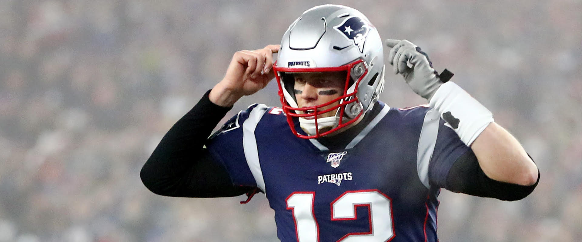 om Brady #12 of the New England Patriots communicates a play at the line of scrimmage in the AFC Wild Card Playoff game against the Tennessee Titans at Gillette Stadium on January 04, 2020 in Foxborough, Massachusetts.