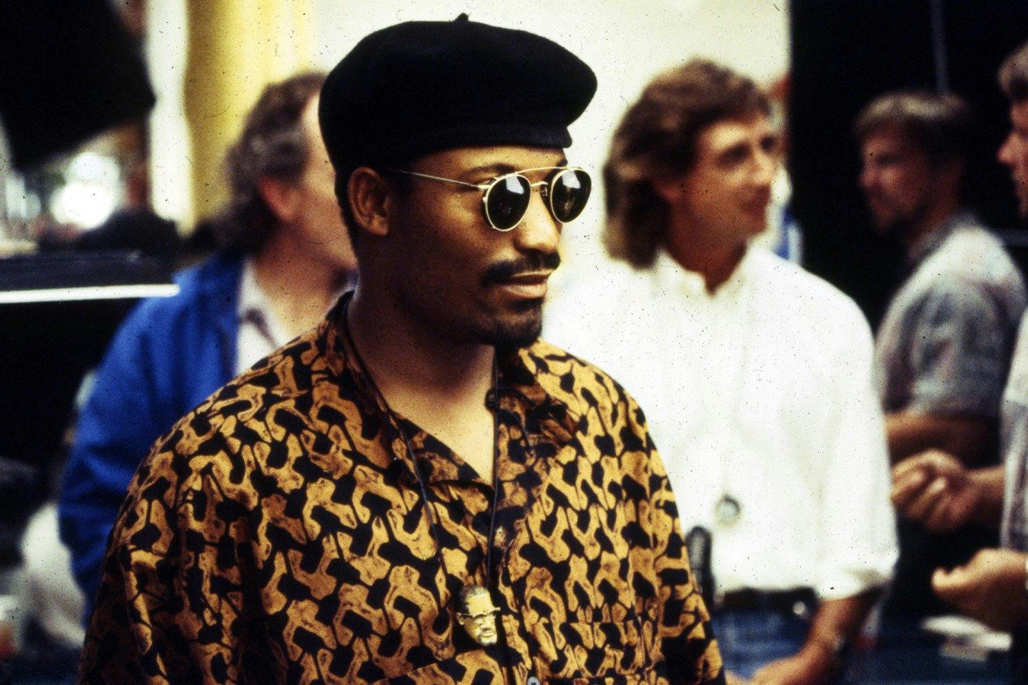 View of director John Singleton, wearing sunglasses and beret, while on the set of his movie 'Poetic Justice', Los Angeles, CA, 1993. 