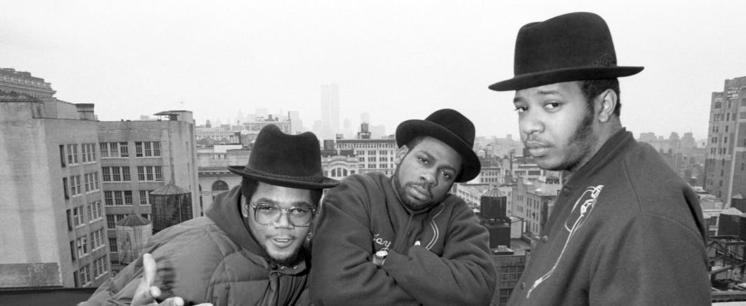 American rapper Darryl "DMC" McDaniels, musician and DJ Jason "Jam Master Jay" Mizell and rapper, producer, DJ and television personality Joseph "Run" Simmons, of the American hip hop group Run-D.M.C, pose for a portrait in New York, New York in August 1985. They are posing on a rooftop with The World Trade Center in the background. 