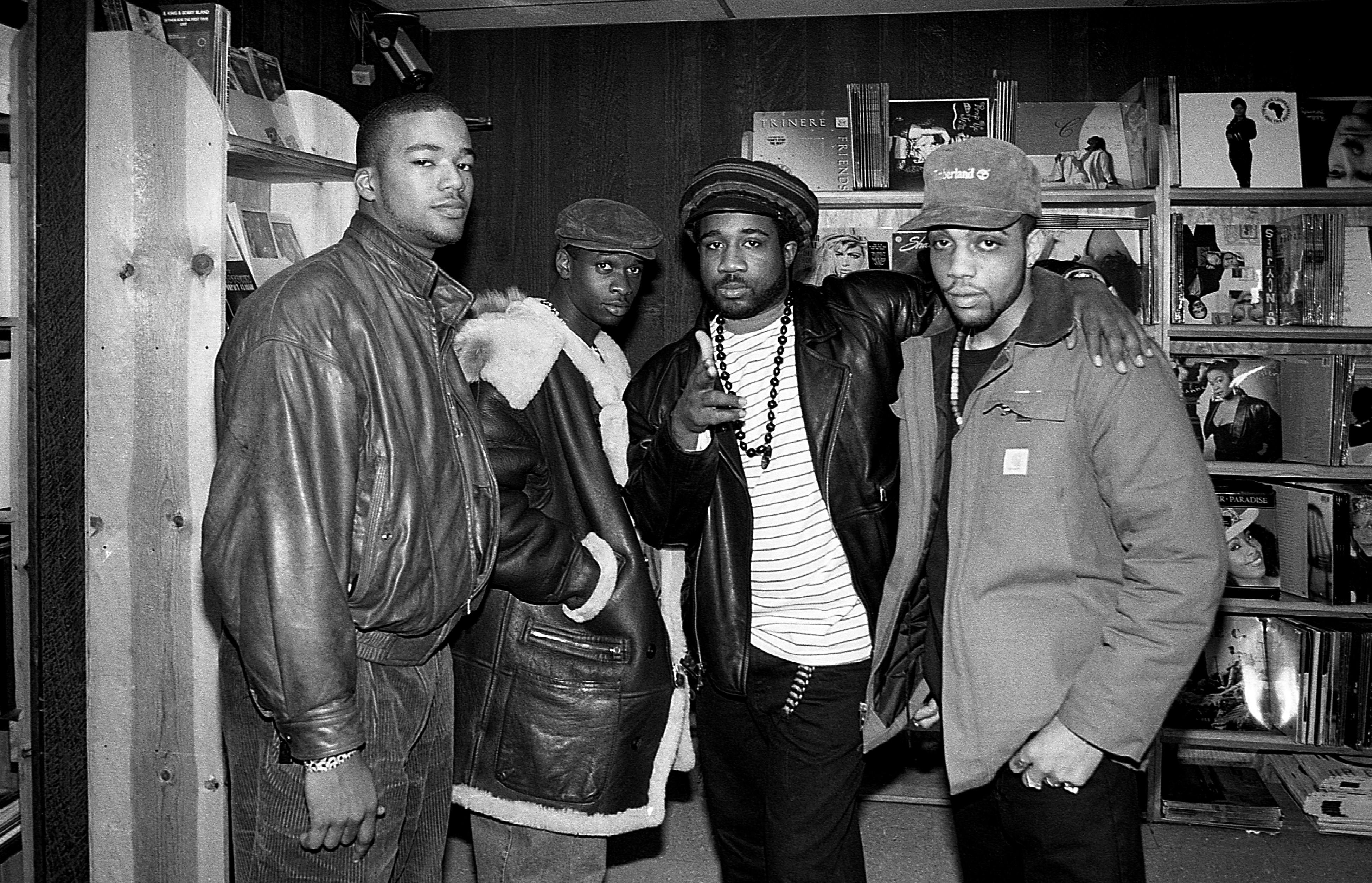Music industry executive Chris Lighty (left) poses for photos with DJ Sammy B. and rappers Mike Gee and Afrika Baby Bam of The Jungle Brothers at Barney's One Stop record store in Chicago, Illinois in February 1990. 