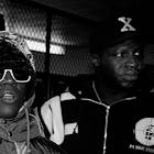 CHICAGO - NOVEMBER 1991: Rappers Tung Twista (Carl Terrell Mitchell) and Flavor Flav (William J. Drayton, Jr.) of Public Enemy poses for photos after participating in a celebrity basketball game at Malcolm X College in Chicago, Illinois in November 1991. 