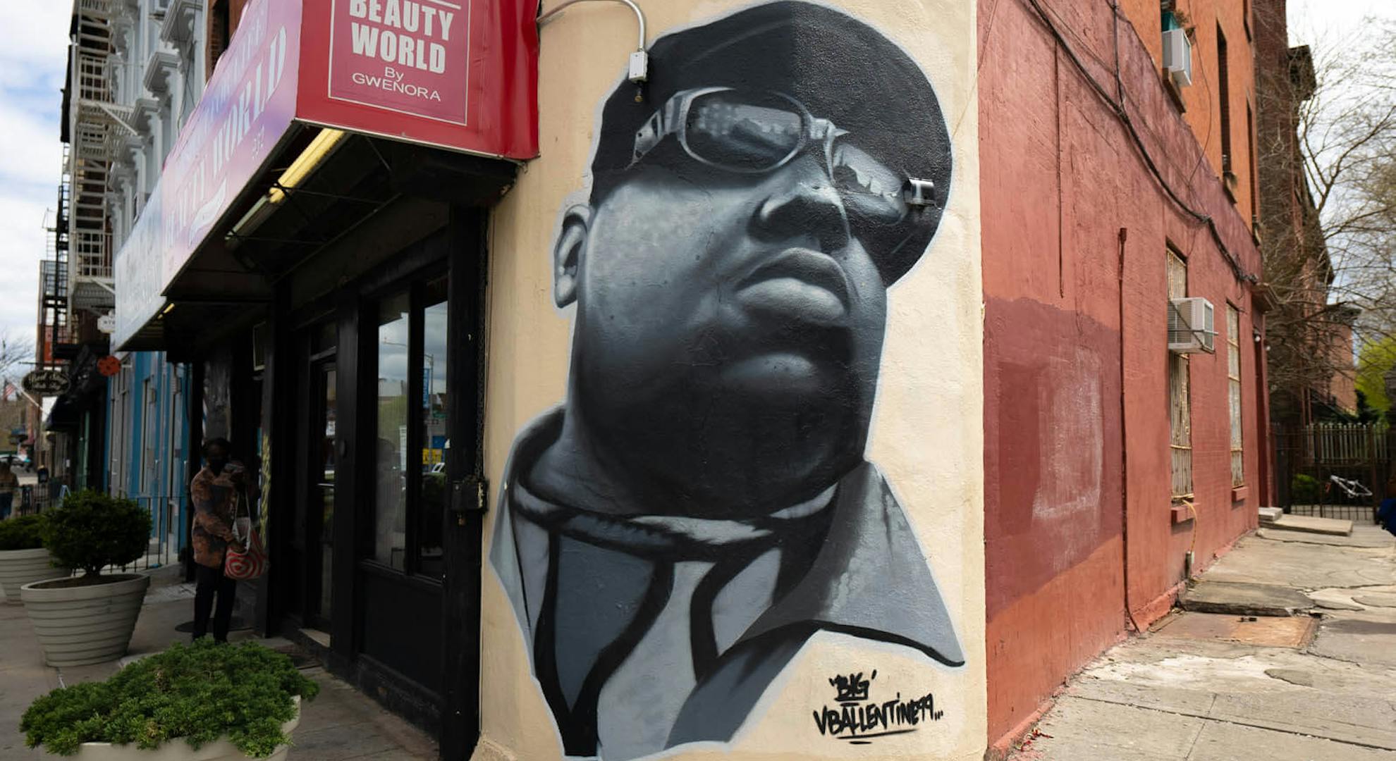 A mural of The Notorious BIG at Respect For Life Barbershop on the corner of Fulton St and St James Pl. by Vincent Ballentine.