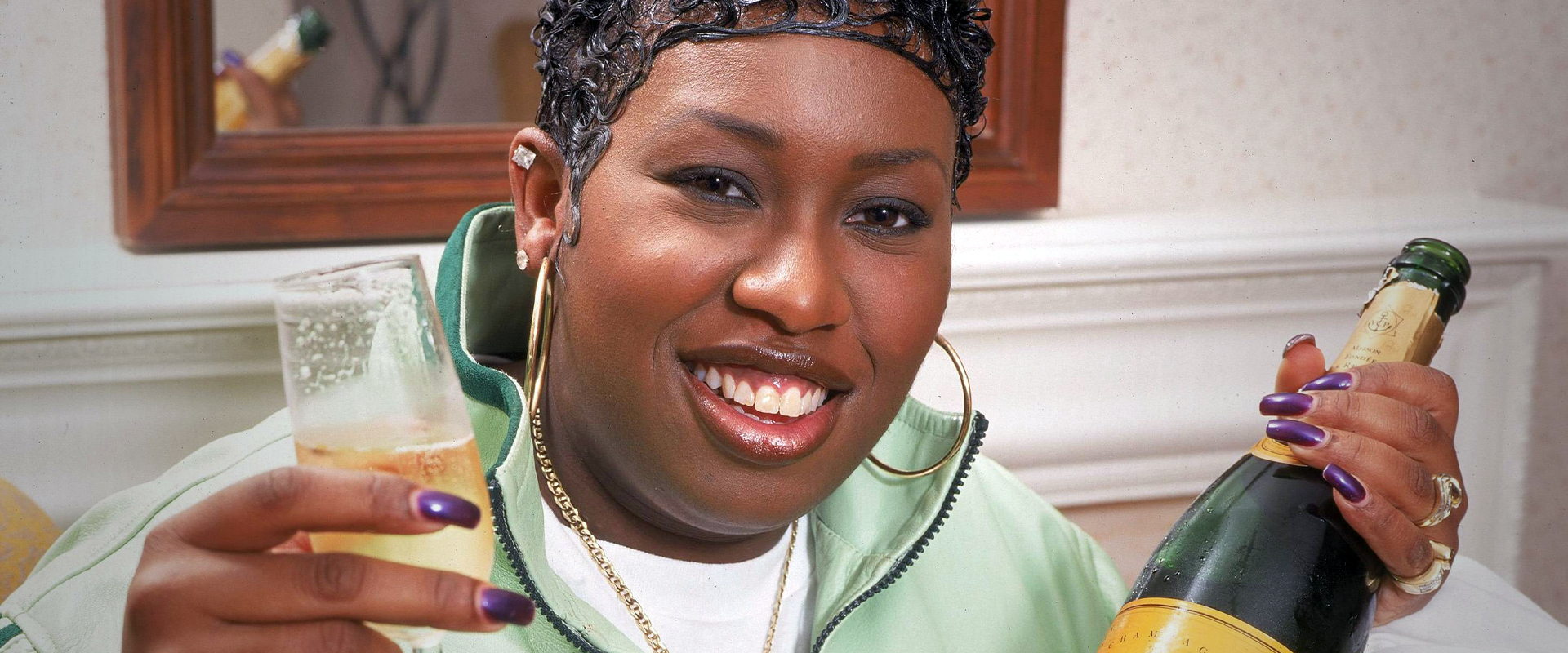 Missy ELLIOTT; posed, holding glass and bottle of champagne (Photo by Mick Hutson/Redferns)